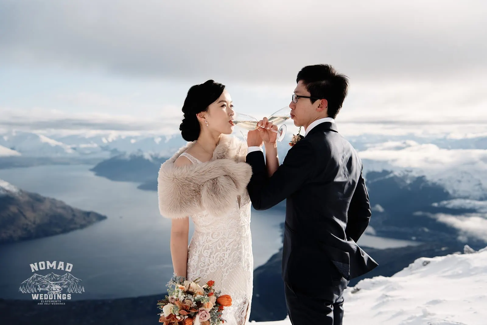Joanna and Tony enjoying a glass of wine during their pre-wedding shoot in snowy Queenstown, New Zealand.