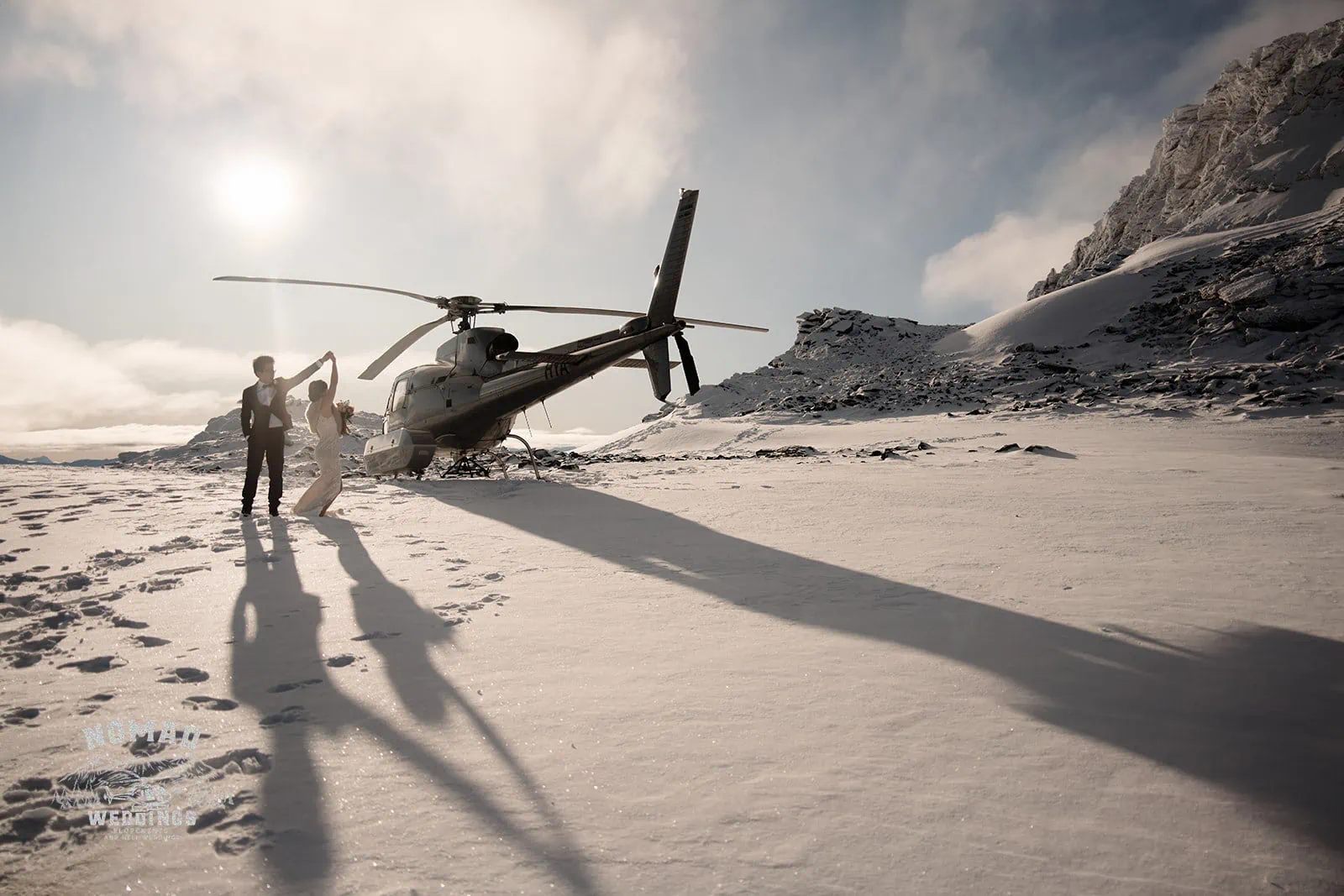 Joanna and Tony pose next to a helicopter during their pre-wedding shoot in snowy Queenstown, New Zealand.