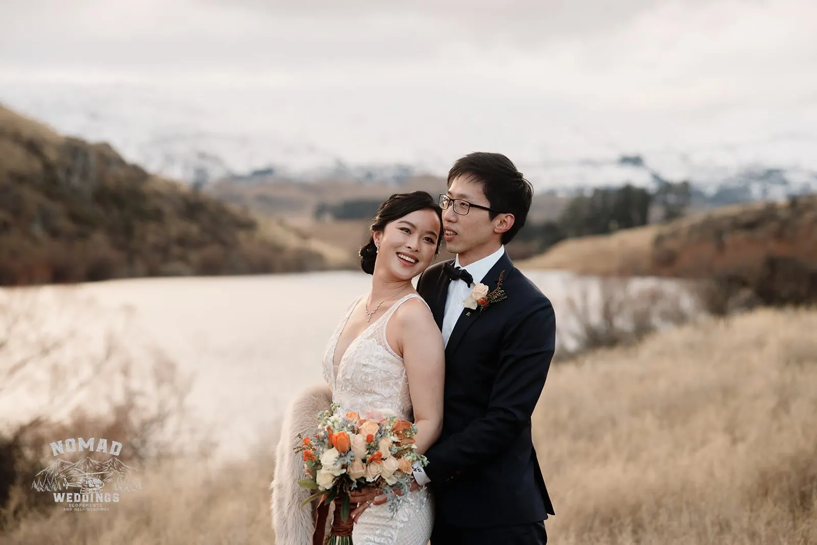 Joanna and Tony's pre-wedding shoot captures the breathtaking scenery of Queenstown, New Zealand, with a stunning lake and mountain backdrop.