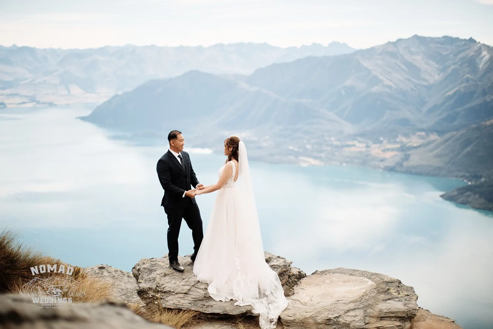 Nhi and Nicholas' pre-wedding shoot on top of a cliff overlooking Lake Wanaka during their Queenstown NZ adventure.