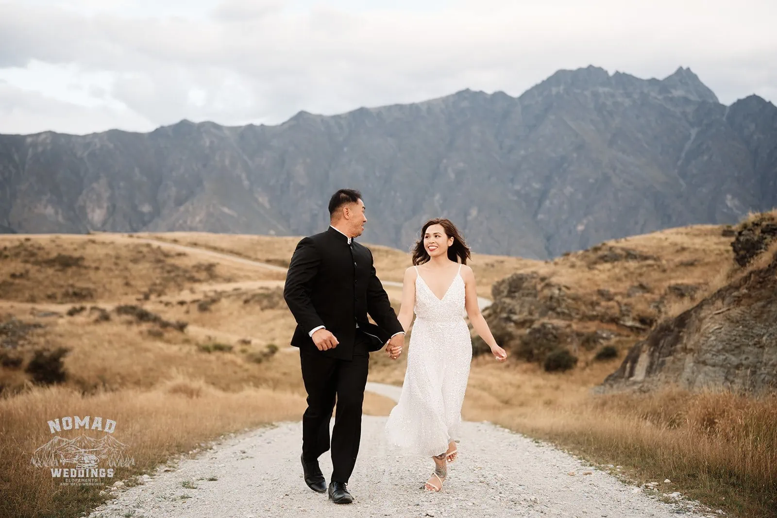 Nhi & Nicholas' Queenstown NZ pre-wedding shoot featuring mountains and a dirt road.