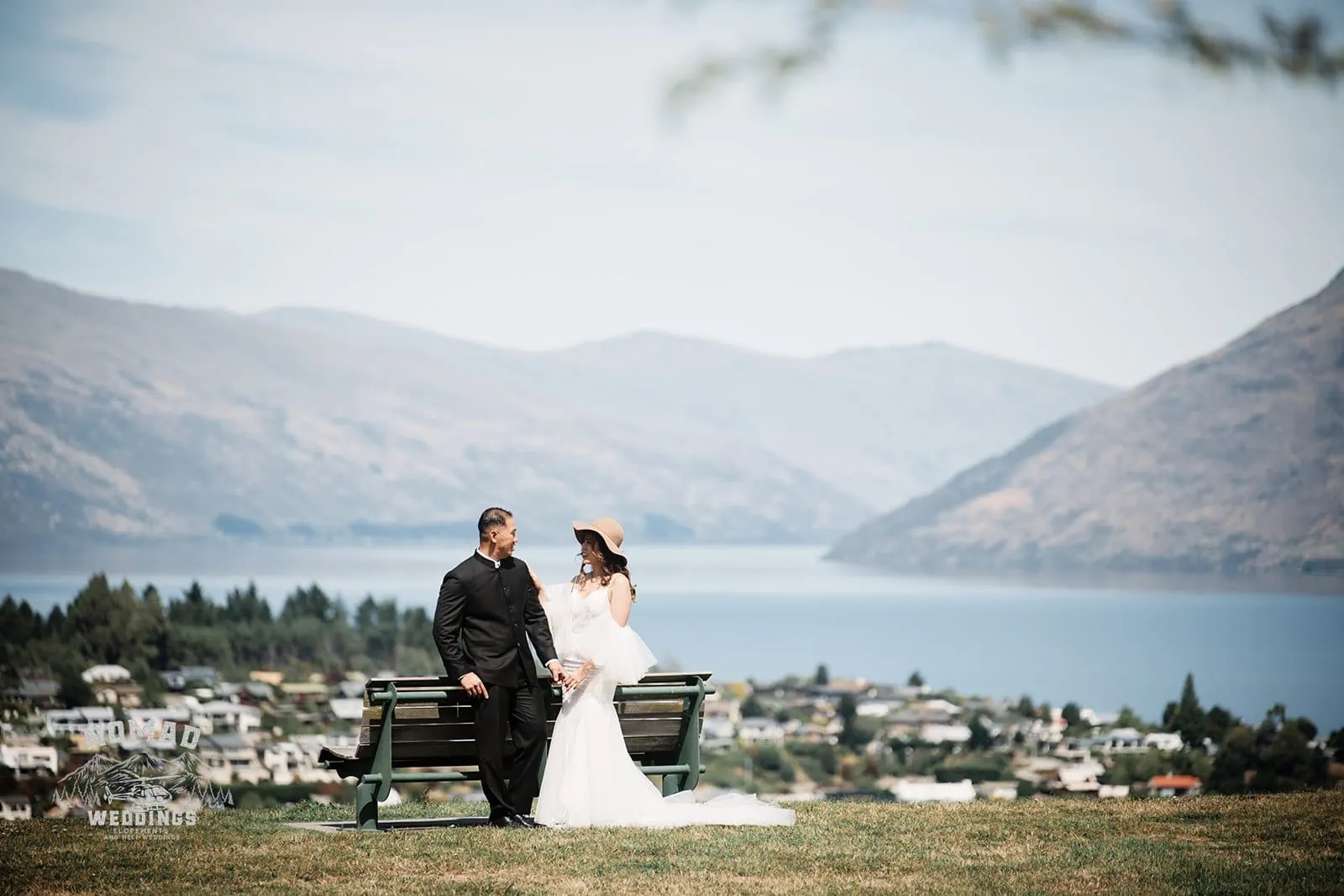A pre-wedding shoot of Nhi & Nicholas on a bench overlooking Lake Wanaka in Queenstown, NZ.