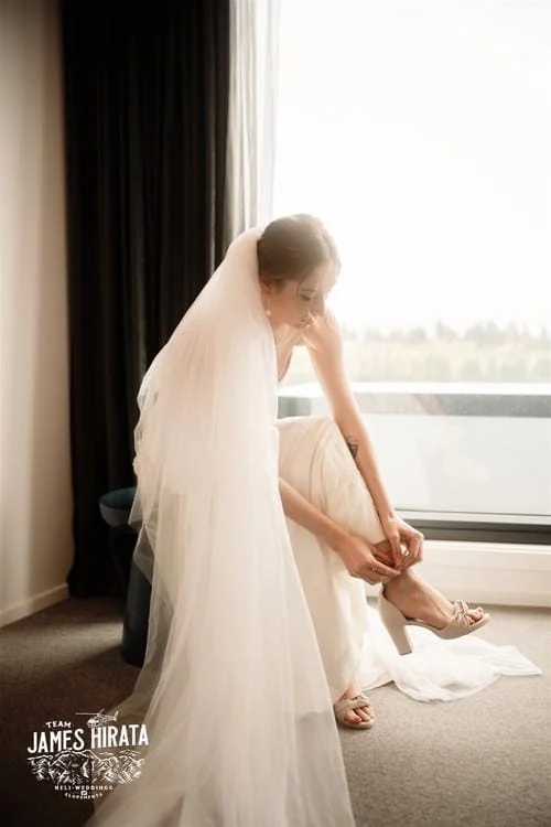 A bride donning her wedding shoes during her Hannah and Ross Elopement Wedding in Queenstown, New Zealand.