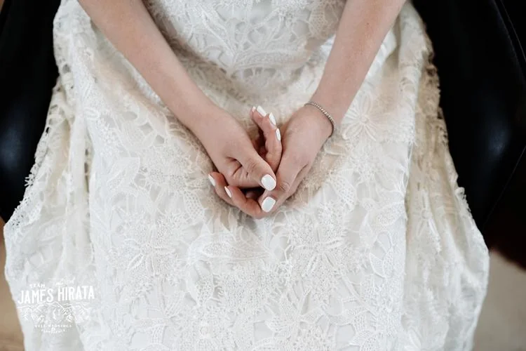Regan & Jake's Queenstown elopement wedding featuring a bride in a white wedding dress sitting on a chair.