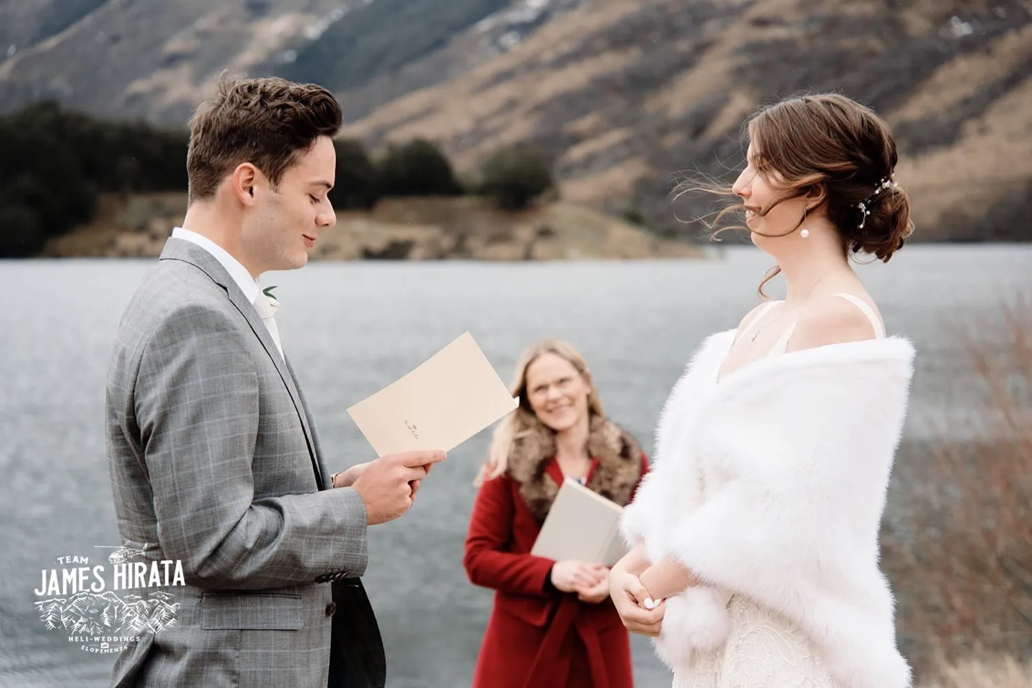 Regan & Jake exchange vows in front of a lake during their Queenstown elopement wedding.