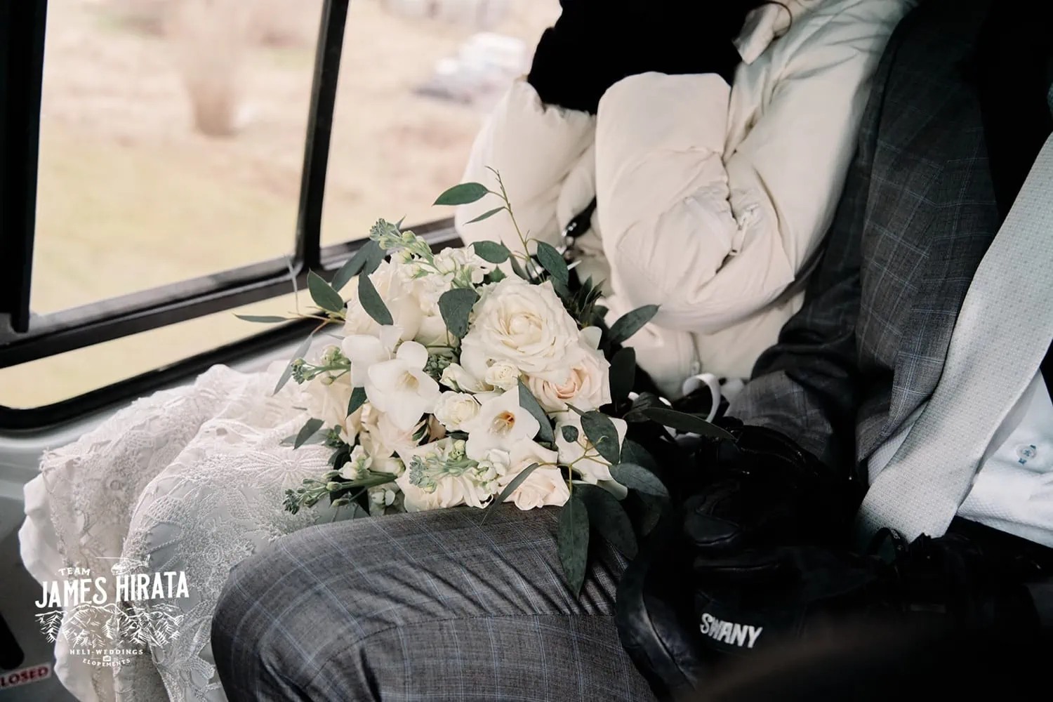 Regan and Jake celebrating their Queenstown elopement wedding inside a bus.