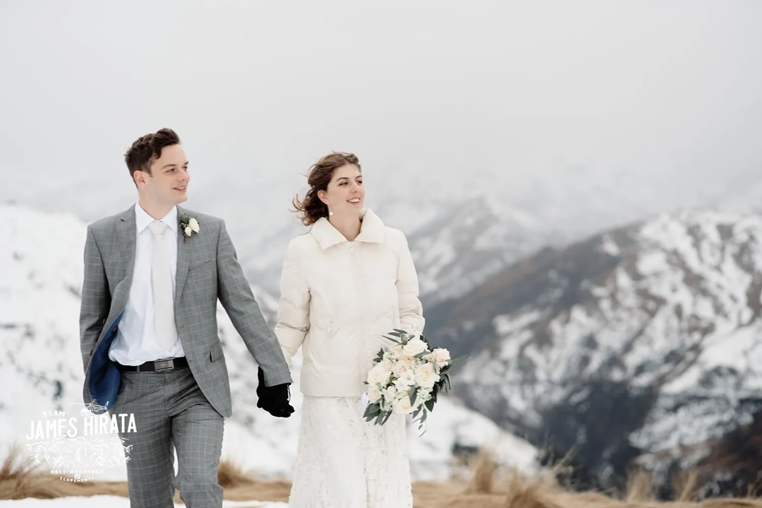 Regan & Jake's elopement wedding takes place on a snow-covered mountain in Queenstown.