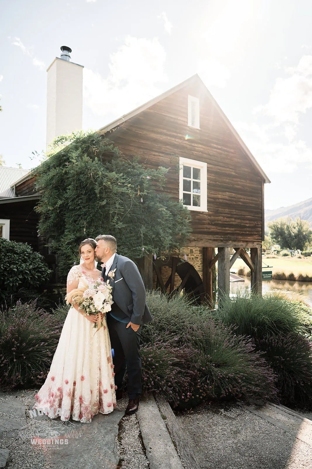 Queenstown New Zealand Elopement Wedding Photographer - A bride and groom standing in front of a barn.