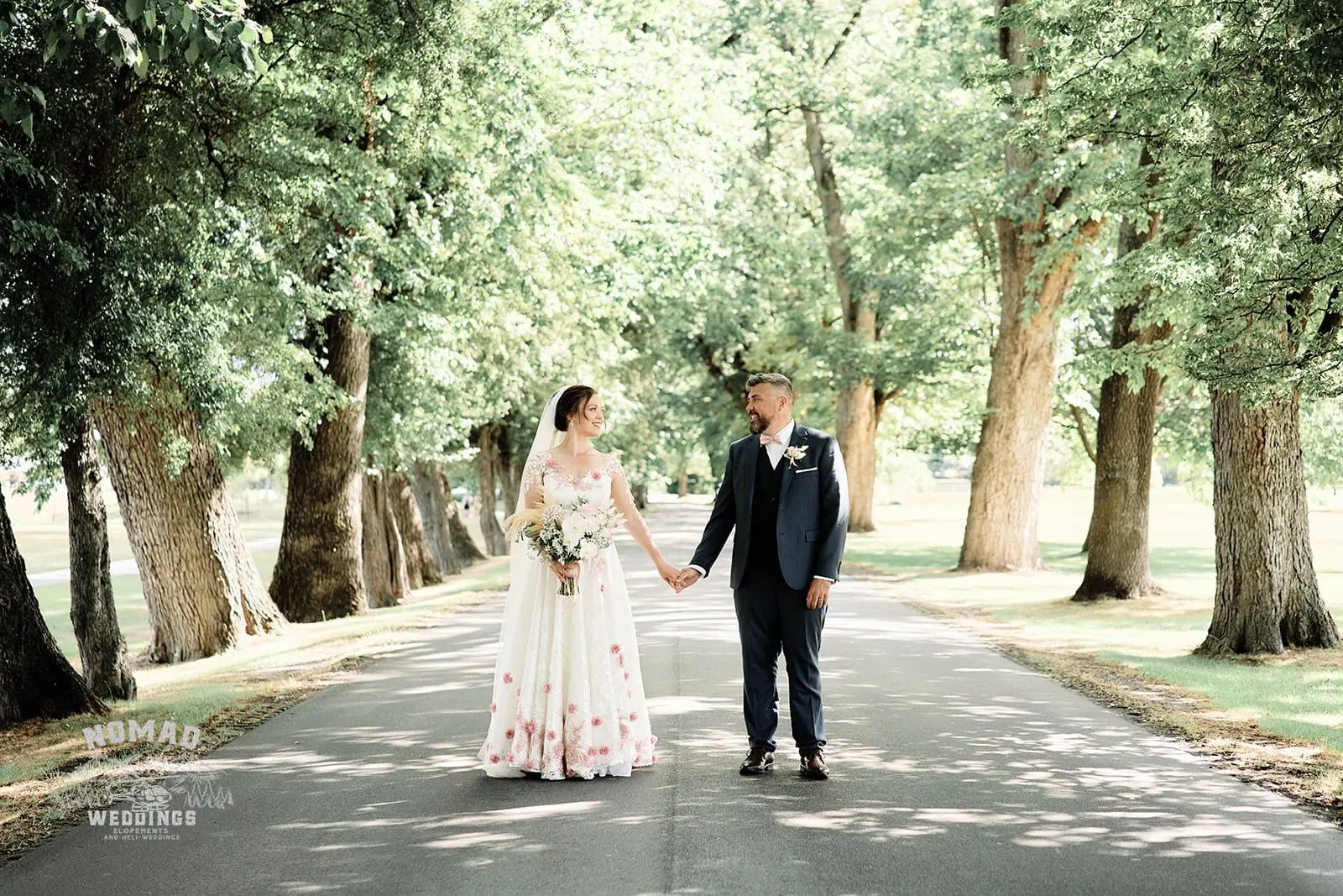Queenstown New Zealand Elopement Wedding Photographer - A couple walking down a path in Queenstown's summer landscapes.