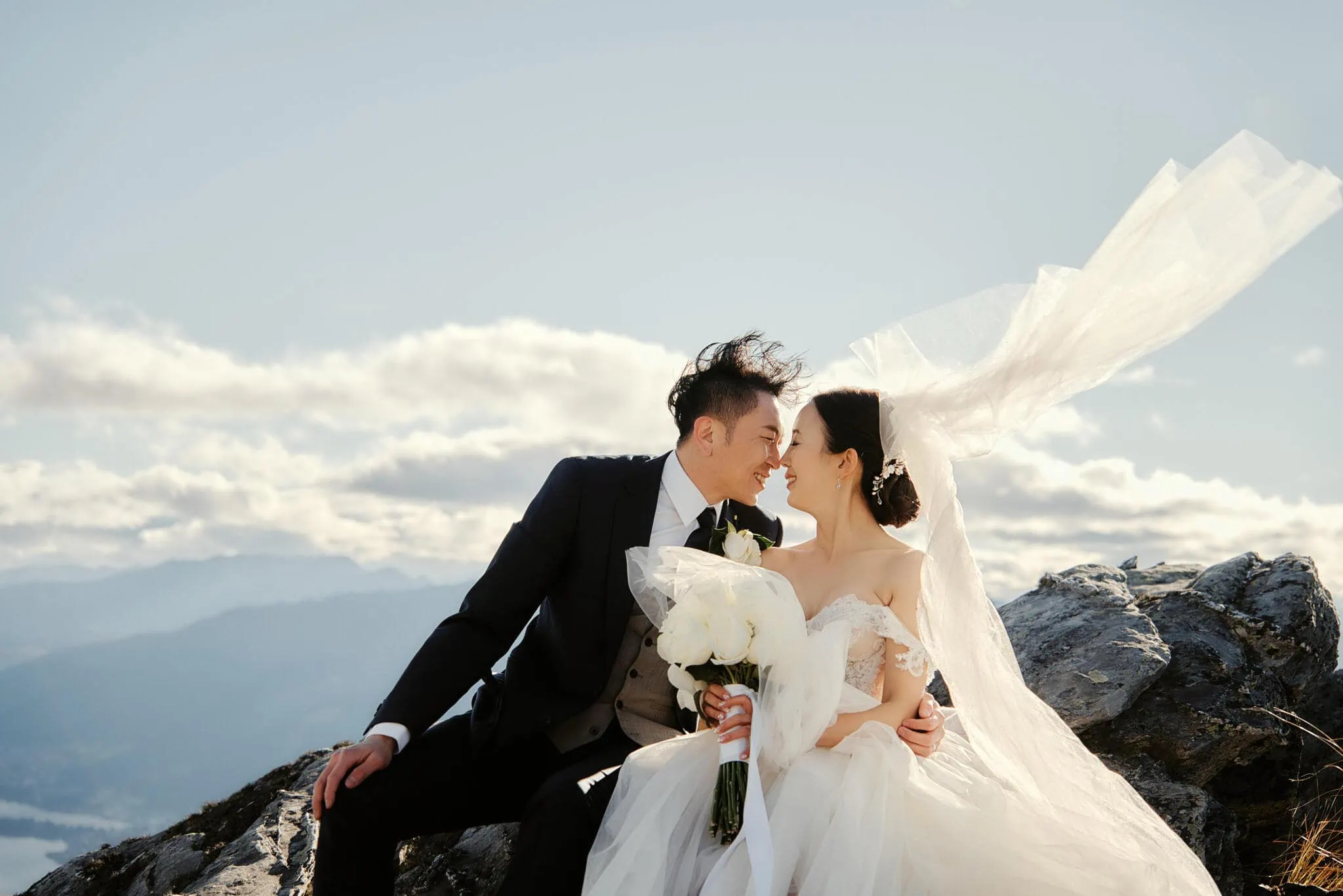 Queenstown New Zealand Elopement Wedding Photographer - Sarah and Tim sharing a sweet kiss during their Scenic Queenstown Heli Elopement Wedding atop a mountain.