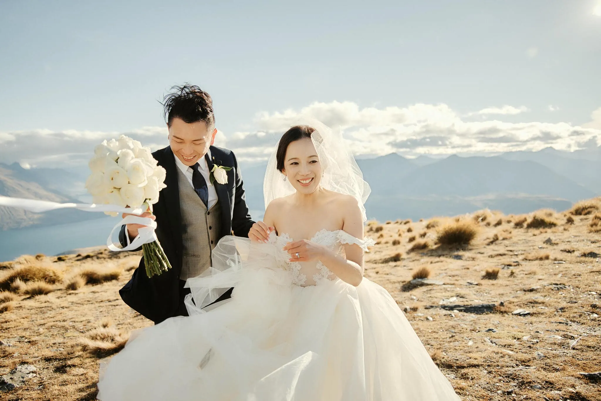 Queenstown New Zealand Elopement Wedding Photographer - Sarah and Tim's Scenic Queenstown Heli Elopement Wedding, with the couple standing on top of a mountain in New Zealand.