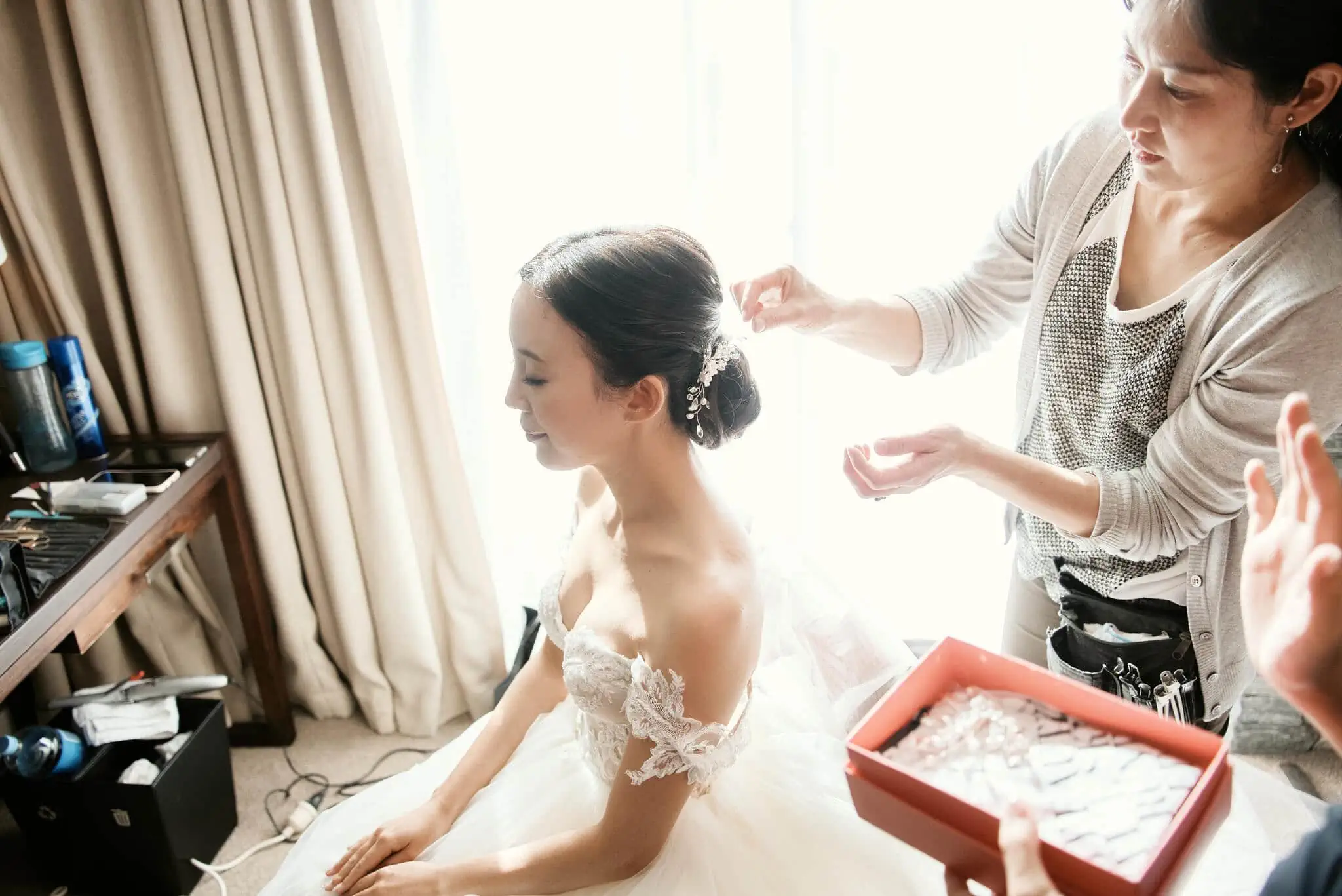 Queenstown New Zealand Elopement Wedding Photographer - Sarah getting her hair done in a hotel room for her scenic Queenstown heli elopement wedding.