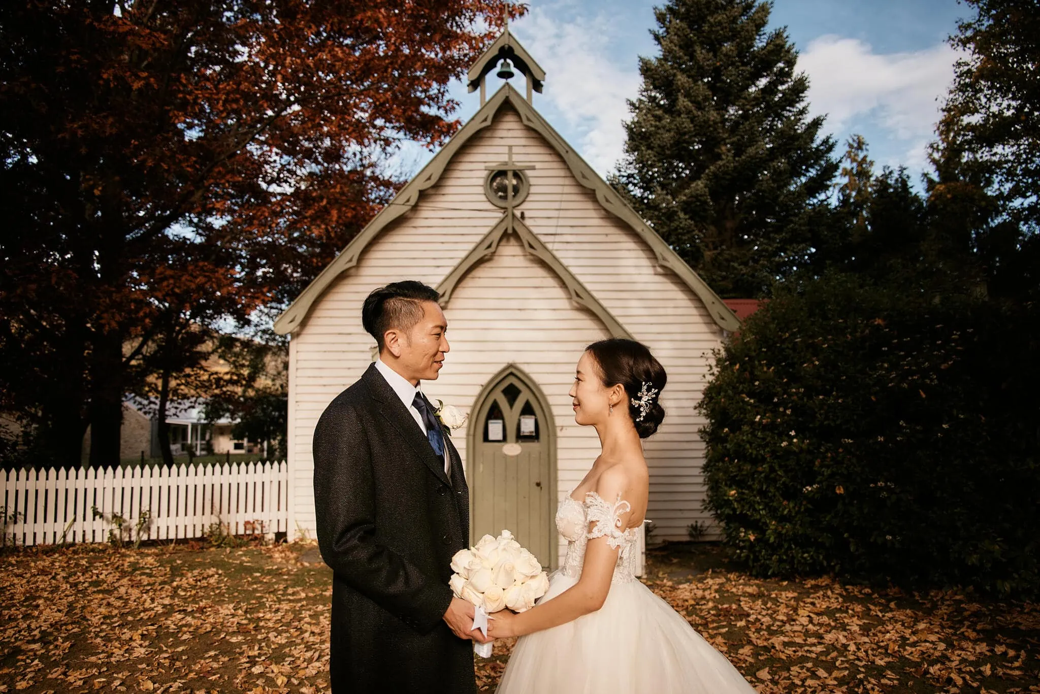 Queenstown New Zealand Elopement Wedding Photographer - Scenic Queenstown heli elopement wedding with Sarah and Tim in front of a white church.