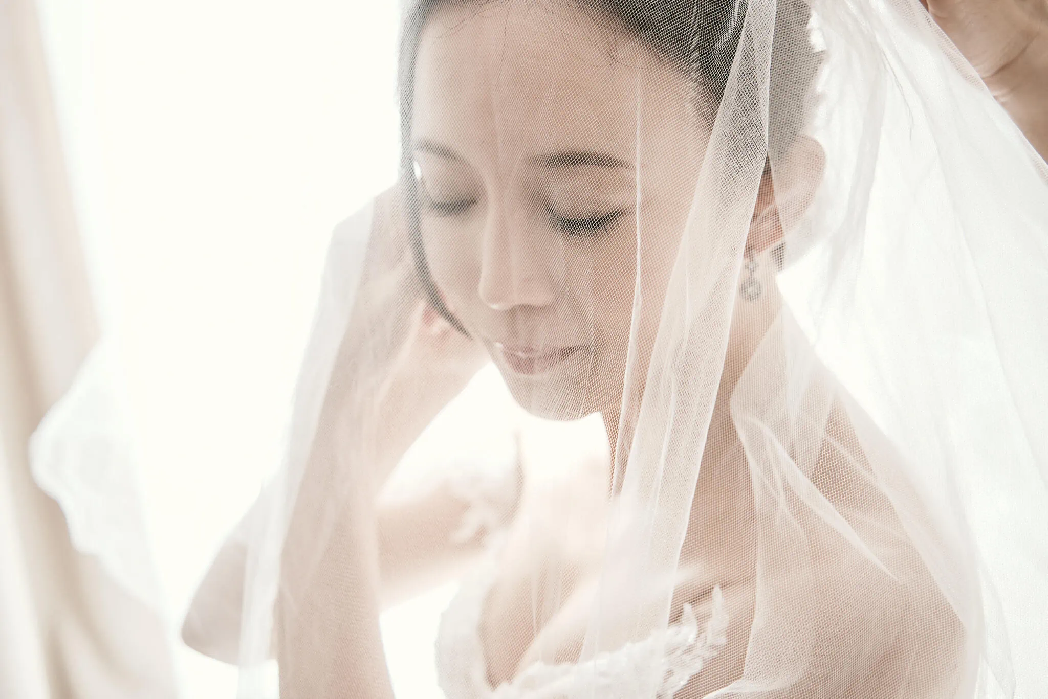 Queenstown New Zealand Elopement Wedding Photographer - Sarah is delicately adorning her wedding veil during their Scenic Queenstown Heli Elopement Wedding.