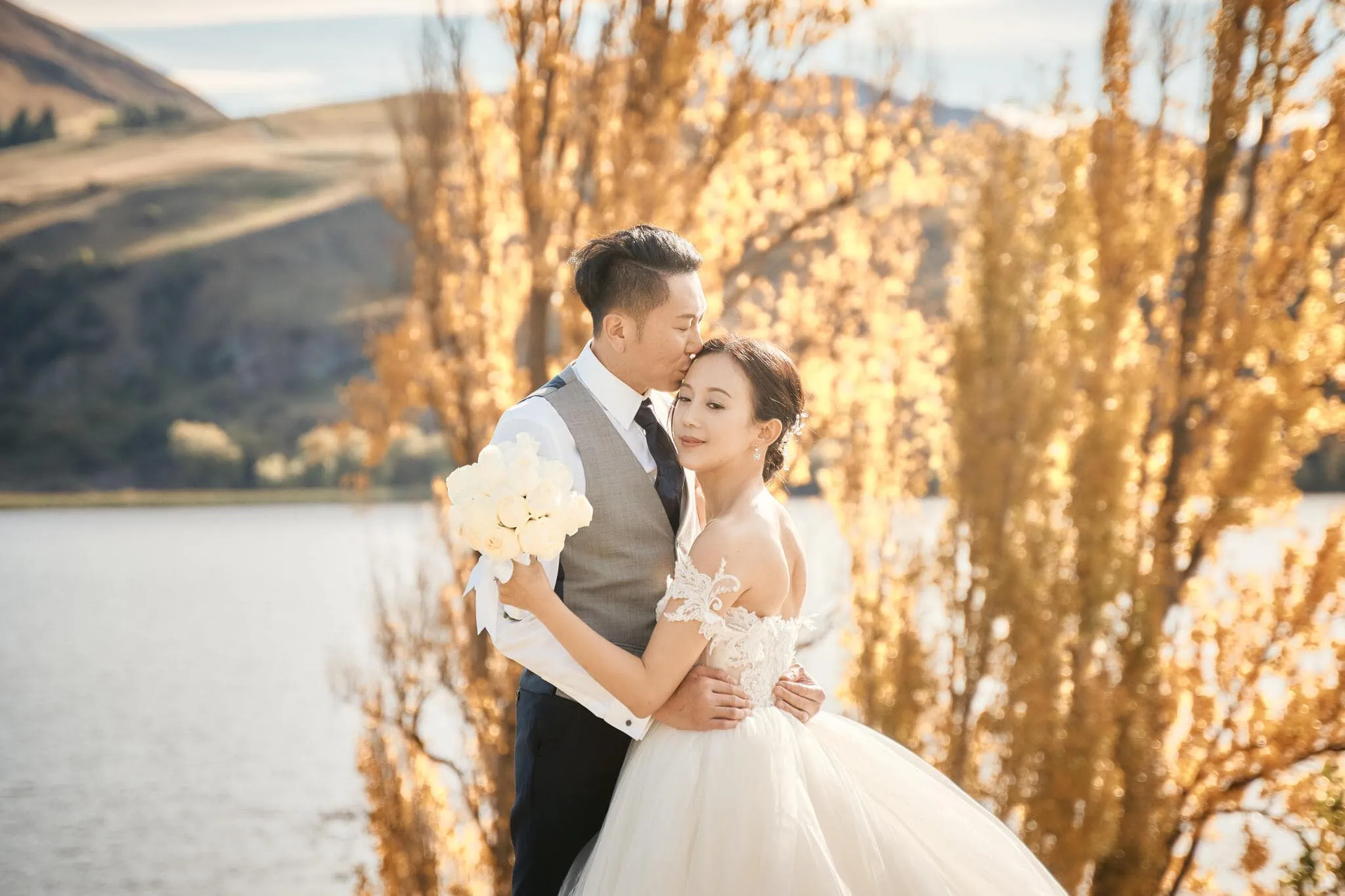 Queenstown New Zealand Elopement Wedding Photographer - Sarah and Tim's scenic Queenstown heli elopement wedding captured as they posed in front of a lake.