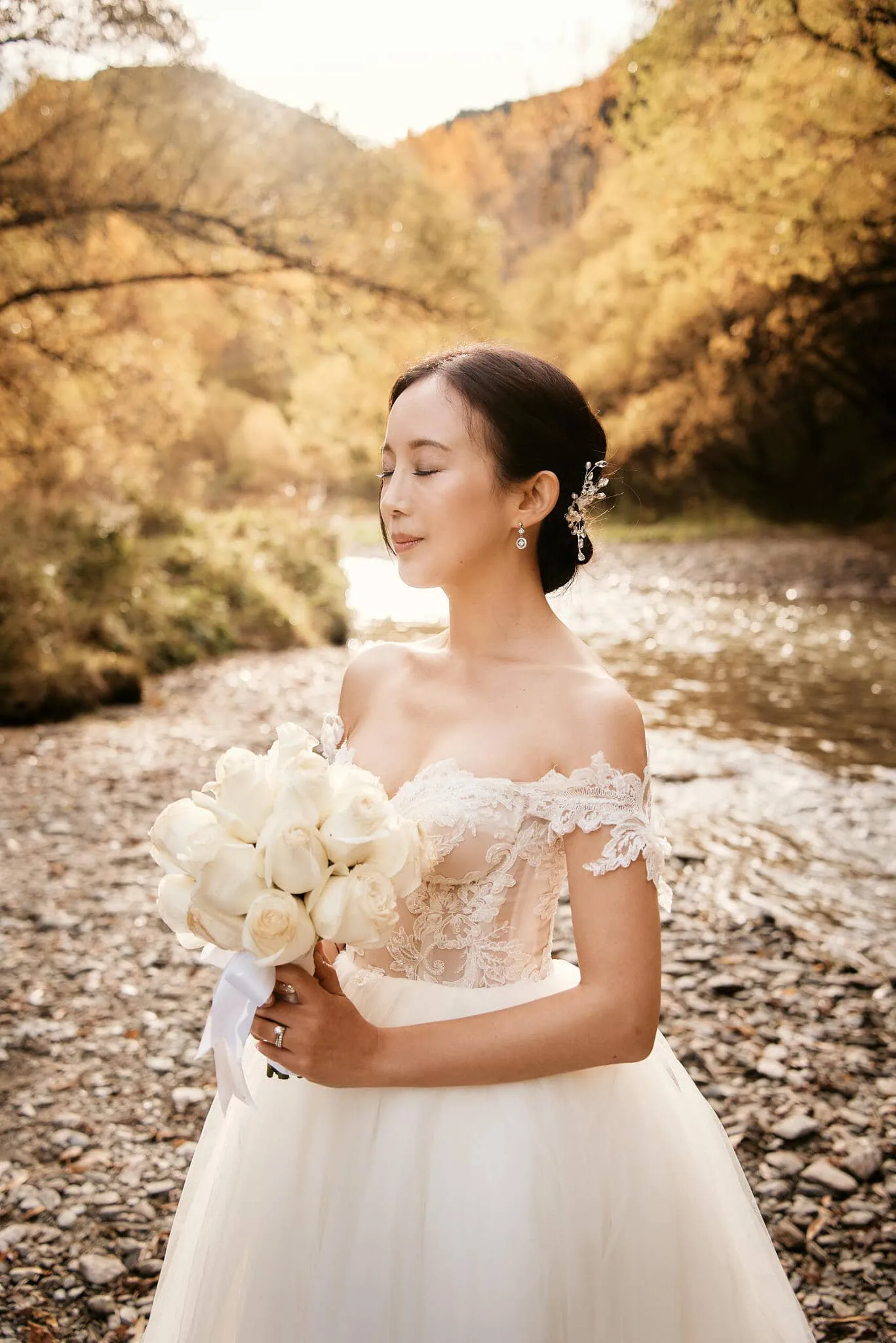 Queenstown New Zealand Elopement Wedding Photographer - Sarah and Tim's scenic Queenstown heli elopement wedding, featuring a bride in a wedding dress standing by a river.