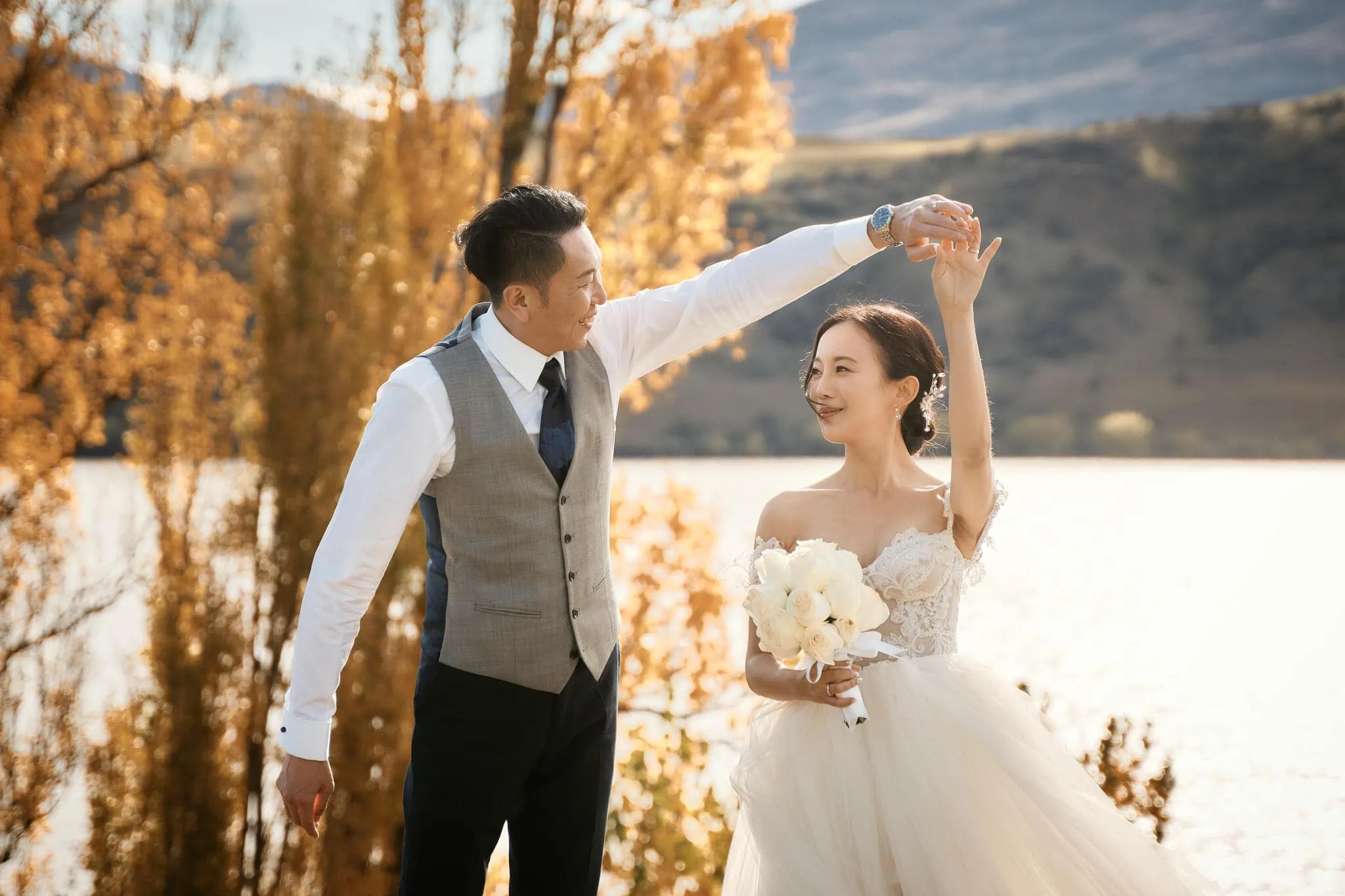 Queenstown New Zealand Elopement Wedding Photographer - Sarah and Tim's scenic Queenstown heli elopement wedding features a bride and groom dancing in front of a lake.