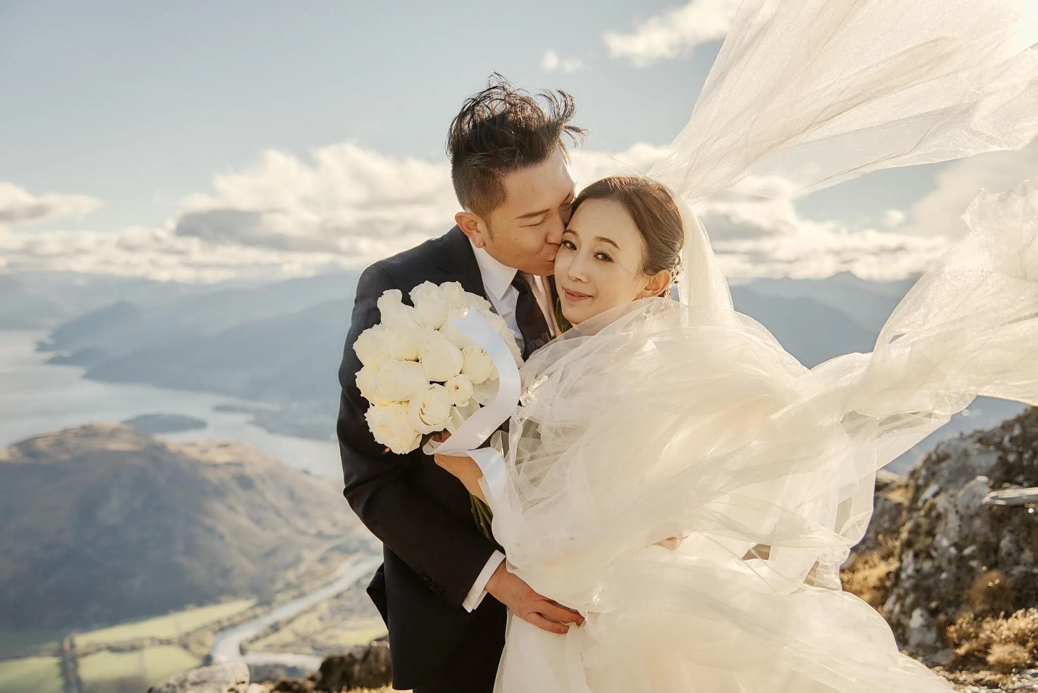 Queenstown New Zealand Elopement Wedding Photographer - Sarah and Tim sharing a passionate kiss during their Scenic Queenstown Heli Elopement Wedding atop a mountain in New Zealand.