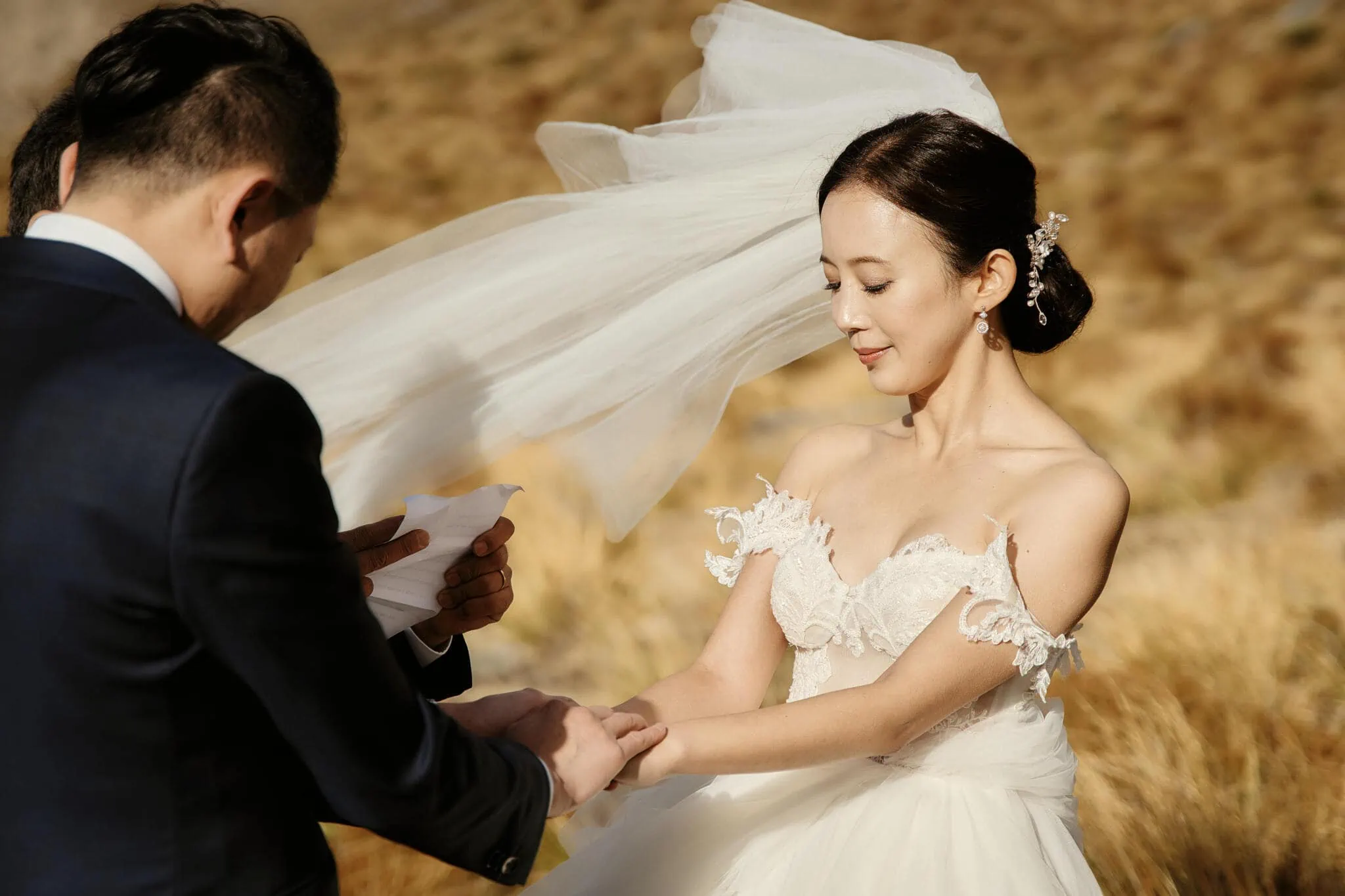 Queenstown New Zealand Elopement Wedding Photographer - Sarah and Tim having their Scenic Queenstown Heli Elopement Wedding in a field.