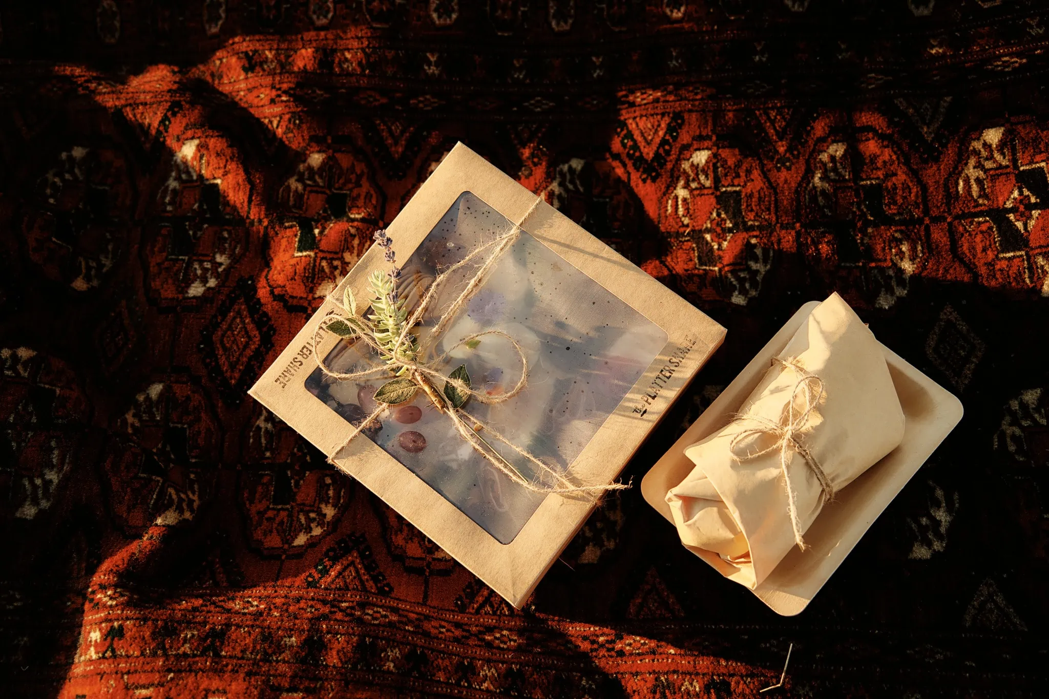 Queenstown New Zealand Elopement Wedding Photographer - Ashleigh and Anthony celebrate their Roy's Peak Heli Elopement Wedding with a box containing a bow, sitting beautifully on a rug.