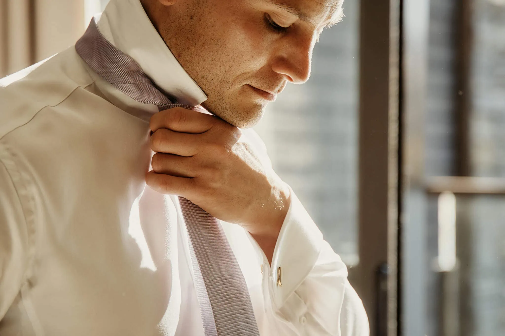 Queenstown New Zealand Elopement Wedding Photographer - A man wearing a white shirt at Queenstown Heli Elopement Wedding.