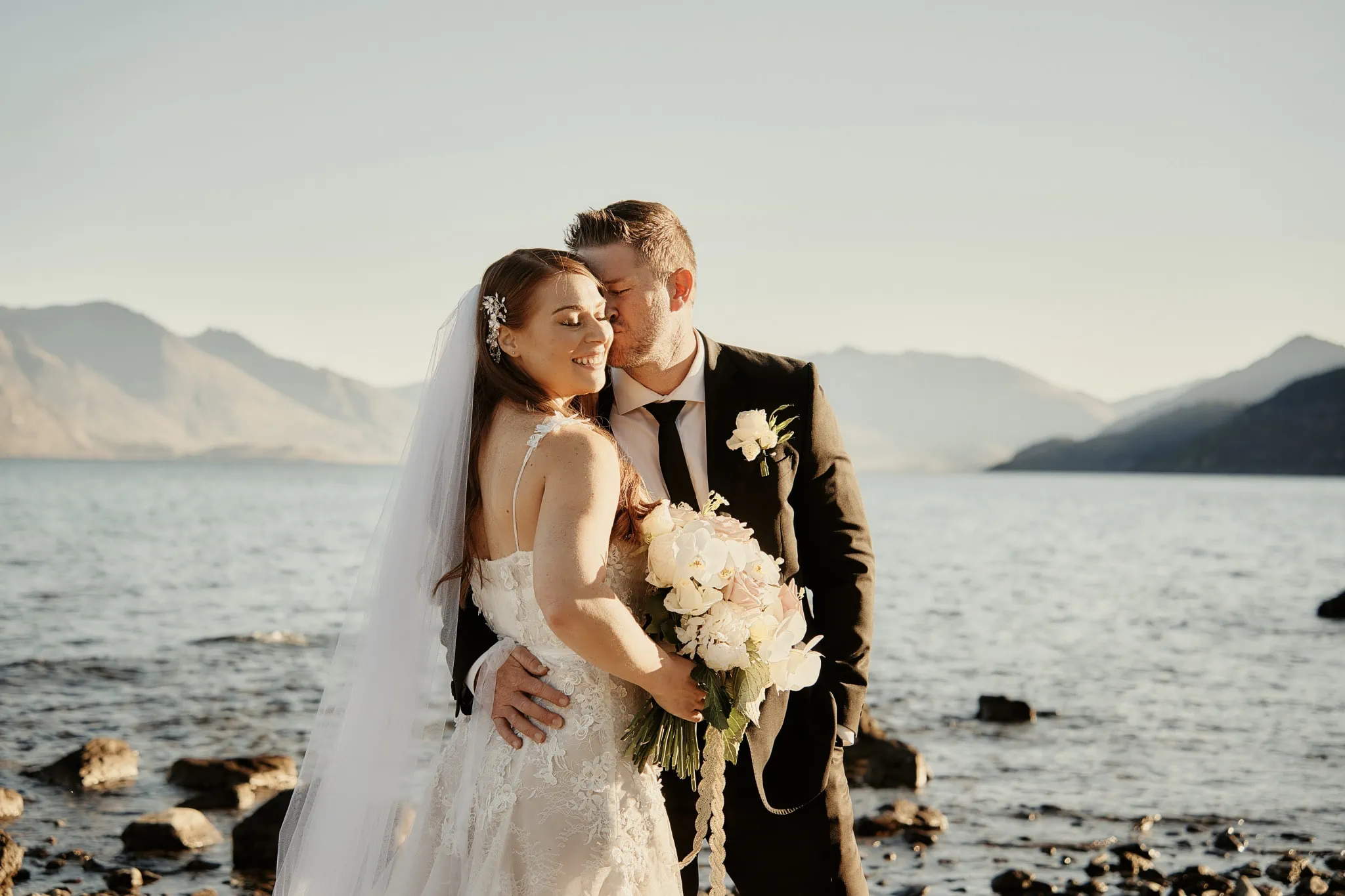Queenstown New Zealand Elopement Wedding Photographer - Ashleigh and Anthony's intimate wedding on the shore of Lake Wanaka captured their blissful embrace.