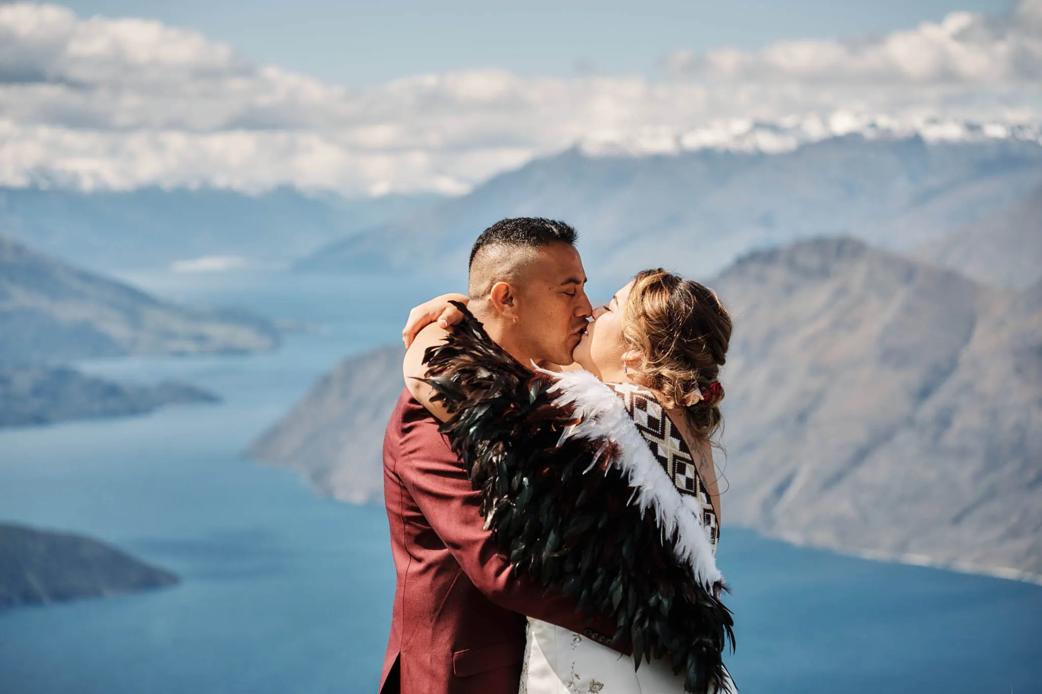 Queenstown New Zealand Elopement Wedding Photographer - Nikita and Terrence share a breathtaking kiss on Coromandel Peak, overlooking Lake Wanaka, during their Heli Elopement Wedding.