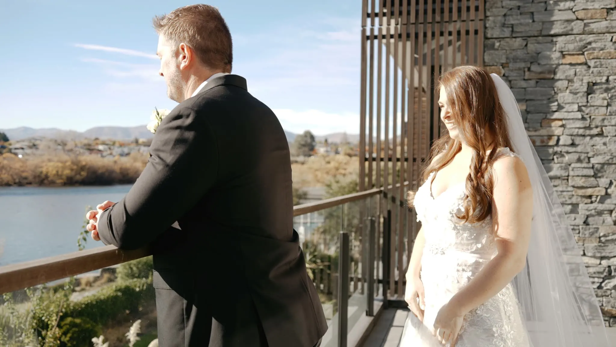 Queenstown New Zealand Elopement Wedding Photographer - Ashleigh and Anthony celebrate their Roy's Peak Heli Elopement Wedding on a balcony, overlooking a lake.