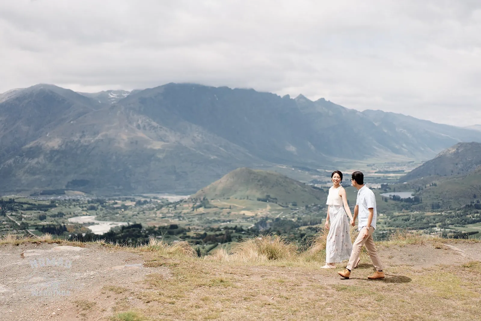 Queenstown New Zealand Elopement Wedding Photographer - A couple on a hill with mountains in the background in Queenstown.