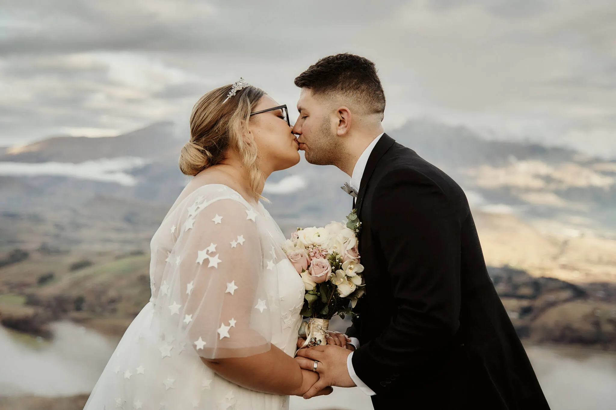 Queenstown New Zealand Elopement Wedding Photographer - Caitiann and Kiyo's Coronet Peak elopement wedding in New Zealand features a kiss on top of a mountain.