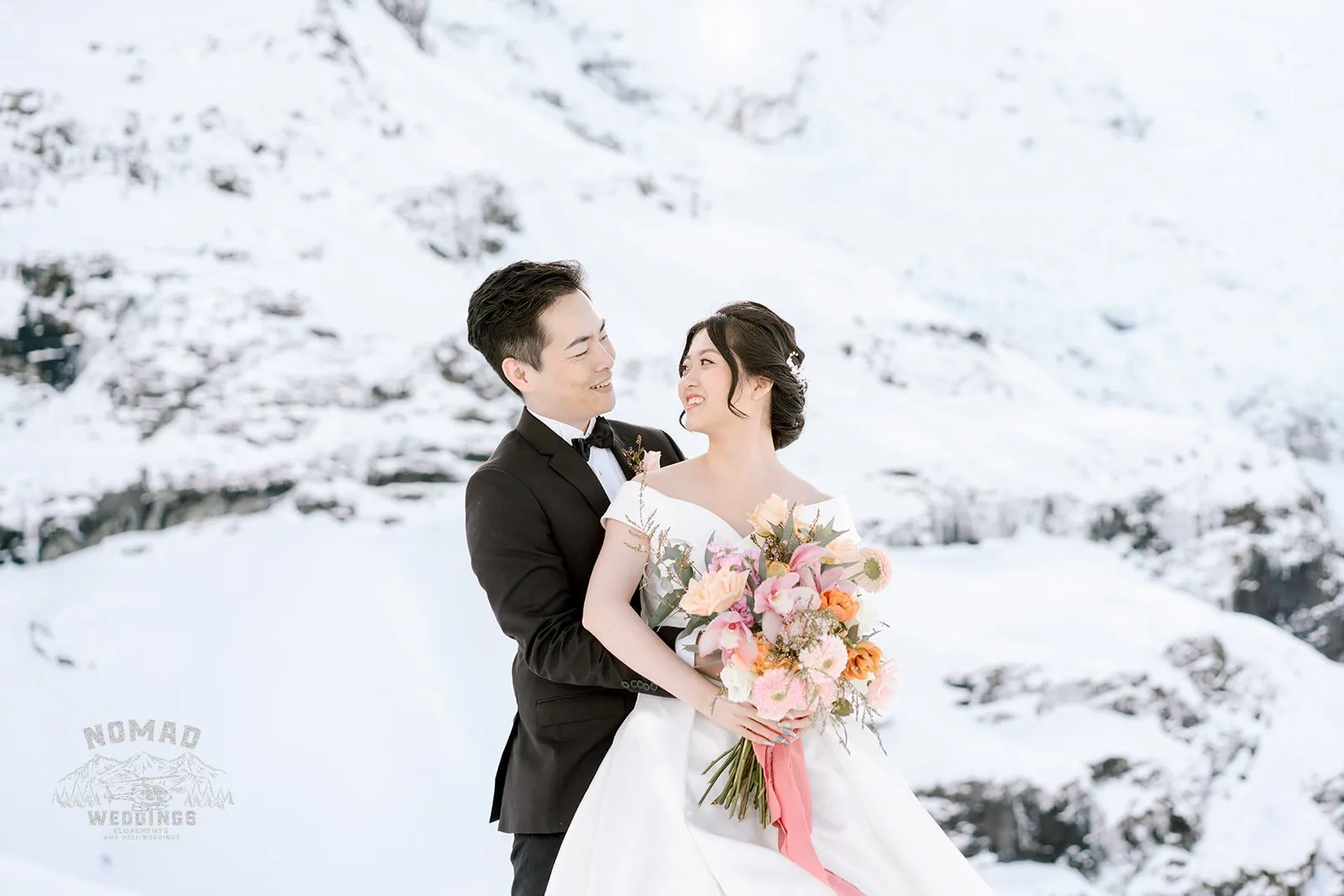 Queenstown New Zealand Elopement Wedding Photographer - Bo and Junyi, a bride and groom, embark on an adventurous Heli Pre Wedding Shoot with 4 landings, capturing breathtaking moments atop a snow covered mountain.