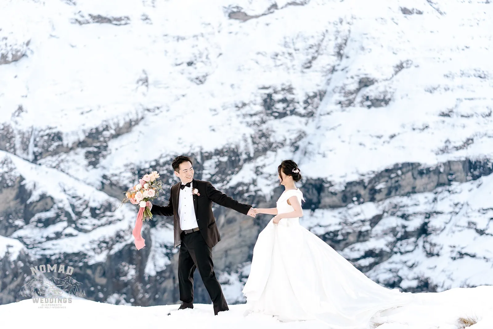 Queenstown New Zealand Elopement Wedding Photographer - Bo and Junyi, a bride and groom, enjoying a Heli Pre Wedding Shoot with 4 Landings on top of a snow covered mountain.
