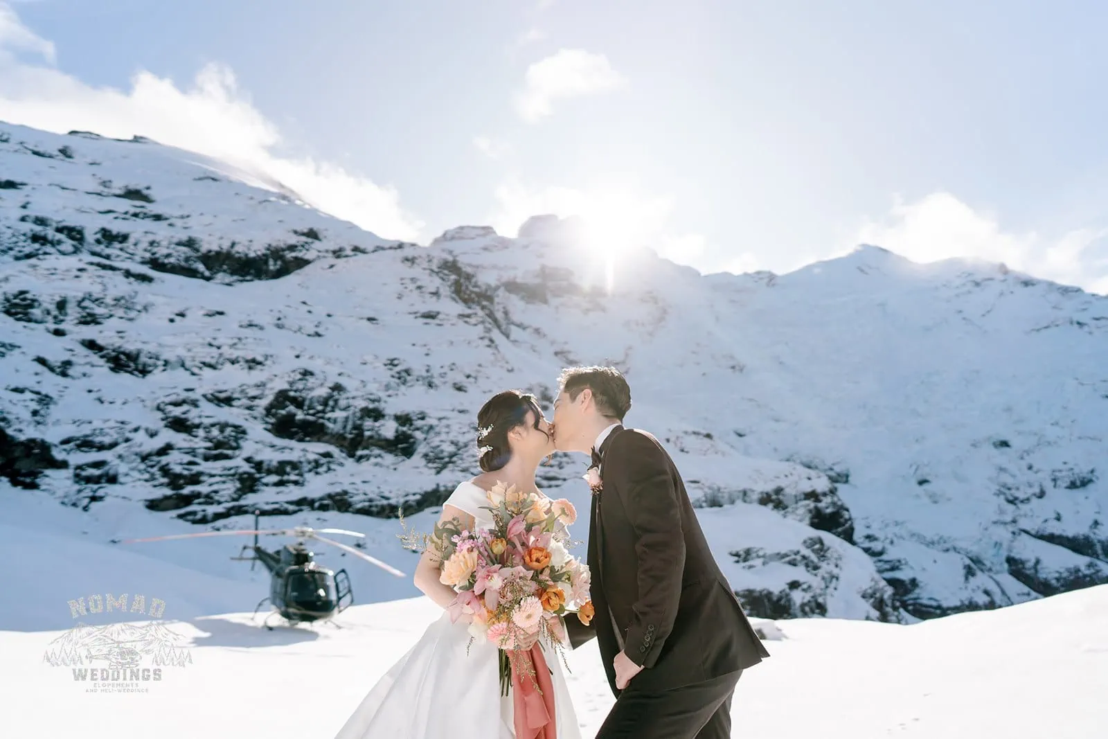 Queenstown New Zealand Elopement Wedding Photographer - A snow-covered mountain serves as the picturesque backdrop for Bo and Junyi during their Heli Pre Wedding Shoot with 4 landings.