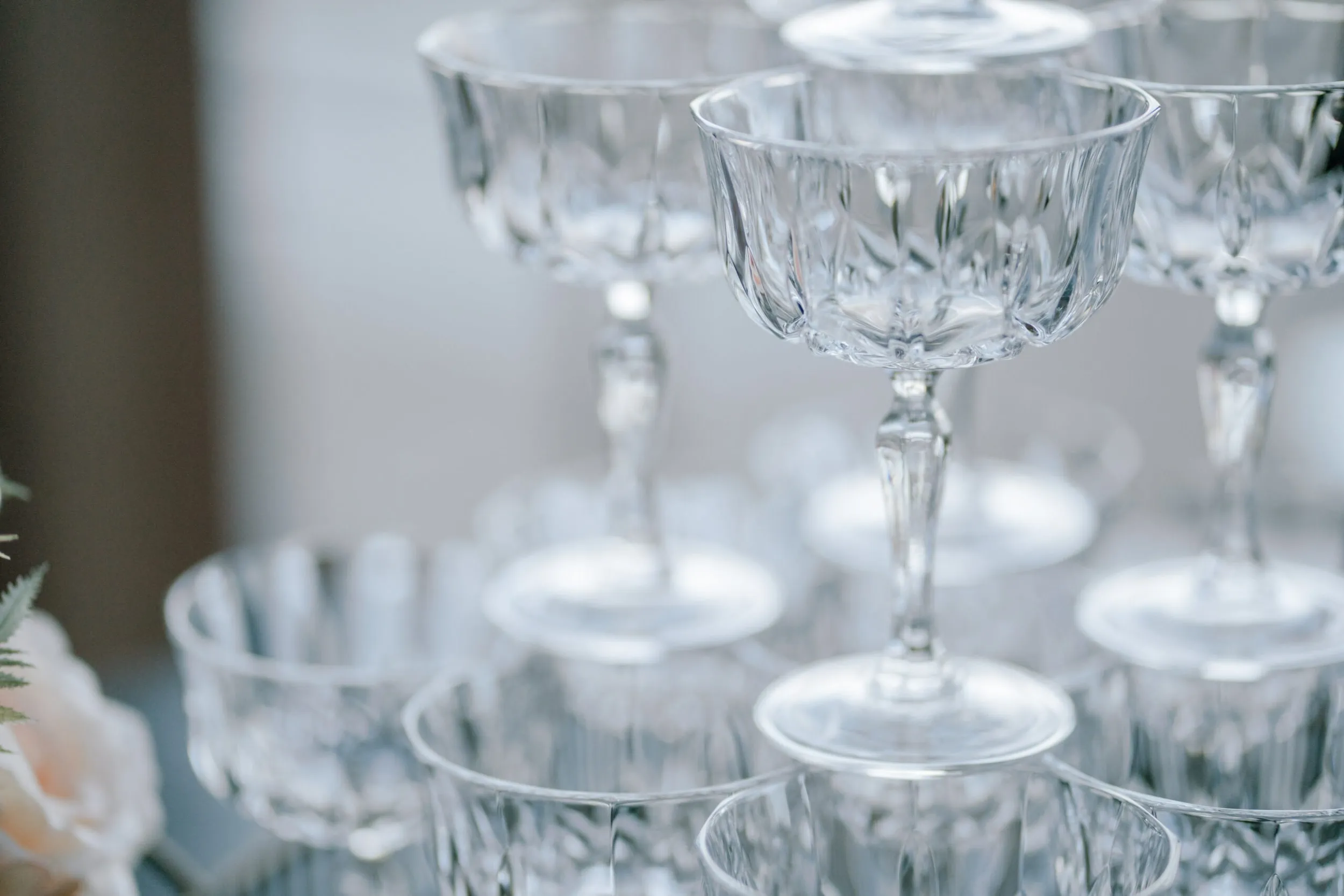 Queenstown New Zealand Elopement Wedding Photographer - Wine glasses are stacked at Lam and Wendy's Kamana Lakehouse wedding.