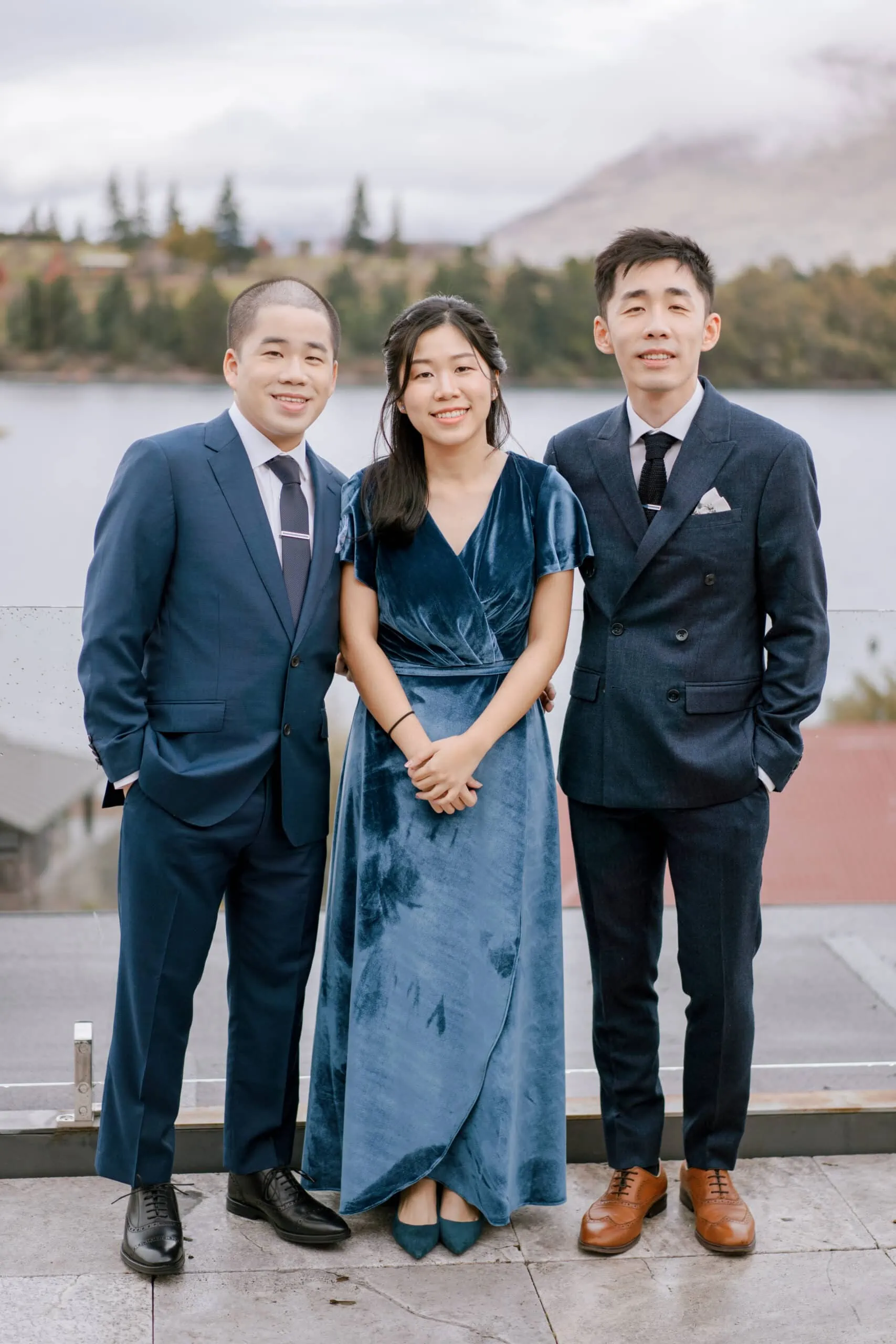 Queenstown New Zealand Elopement Wedding Photographer - Asian people posing for a photo in front of Kamana Lakehouse.