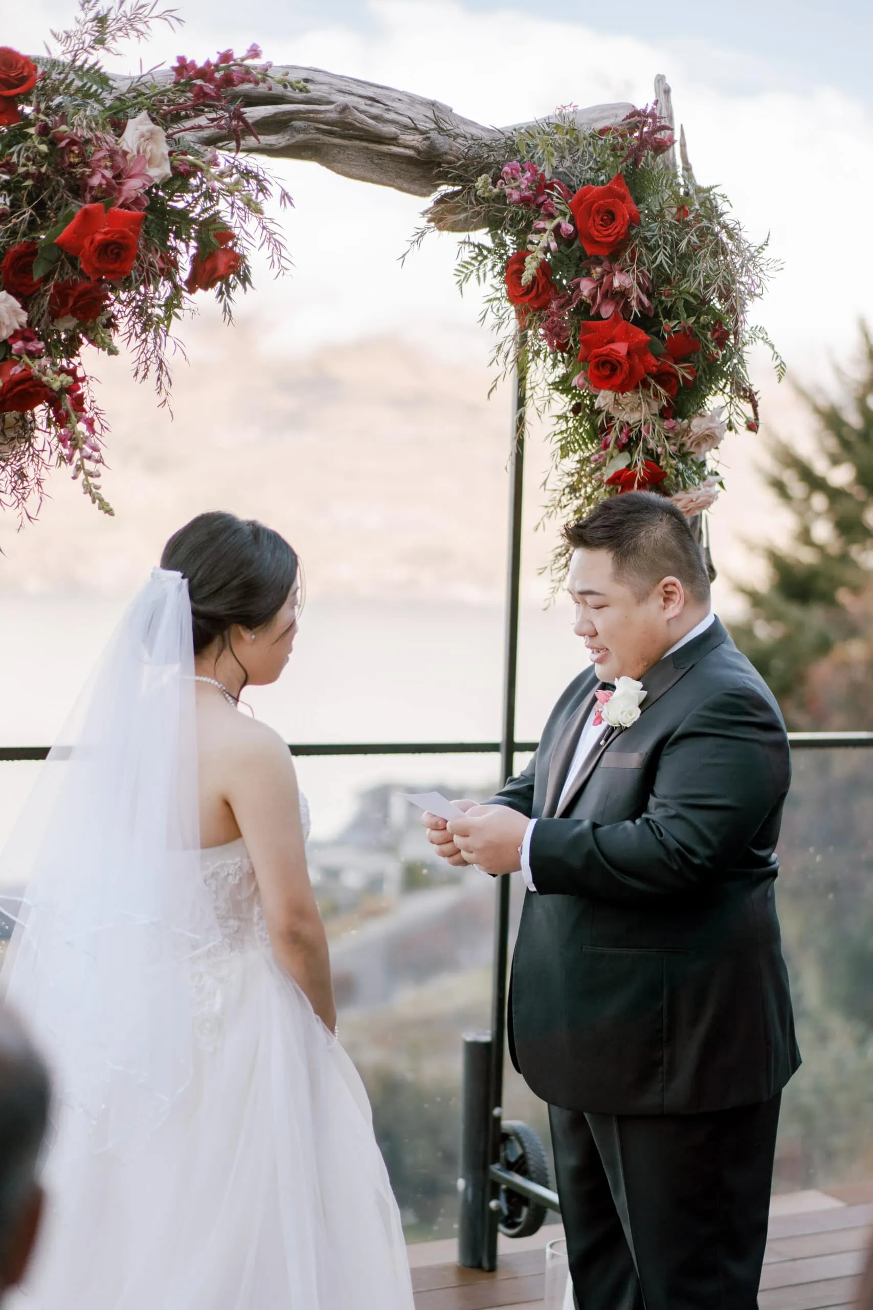 Queenstown New Zealand Elopement Wedding Photographer - Lam and Wendy exchange rings at their Kamana Lakehouse wedding ceremony.