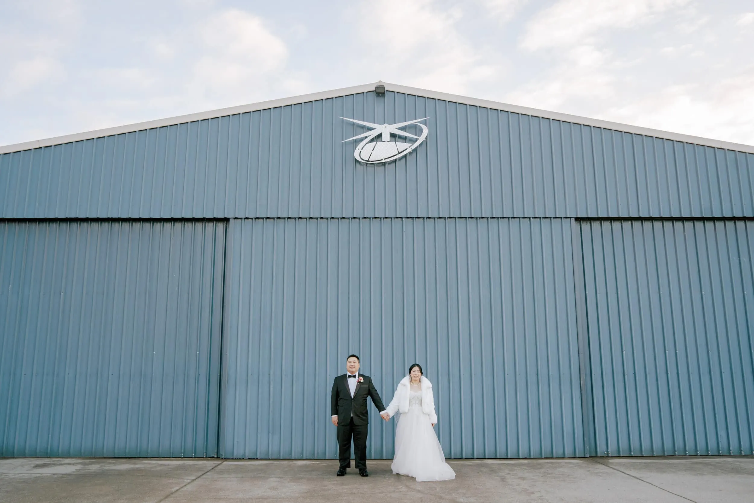 Queenstown New Zealand Elopement Wedding Photographer - Lam and Wendy's wedding shoot in front of a blue hangar.