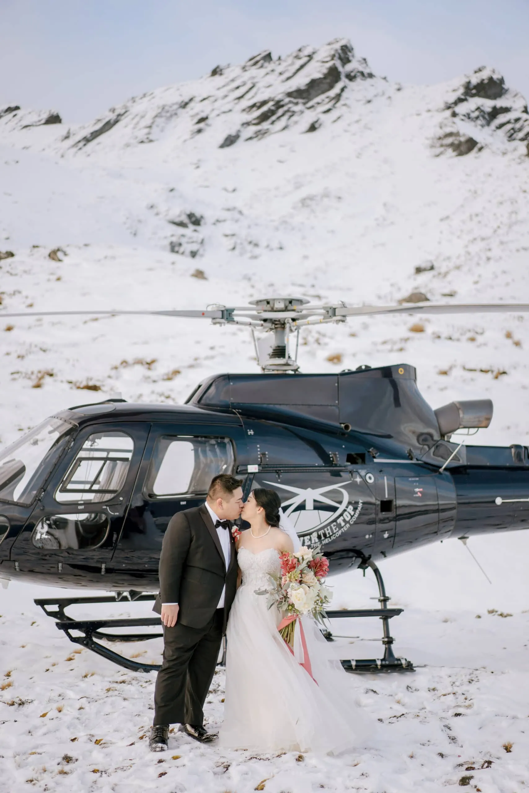 Queenstown New Zealand Elopement Wedding Photographer - A snowy wedding shoot featuring Lam and Wendy's helicopter at Kamana Lakehouse.
