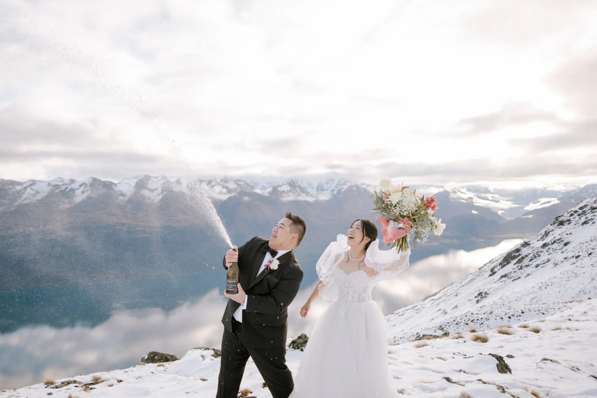 Queenstown New Zealand Elopement Wedding Photographer - Lam and Wendy's unique Kamana Lakehouse wedding includes a thrilling heli shoot on a snow-covered mountain.