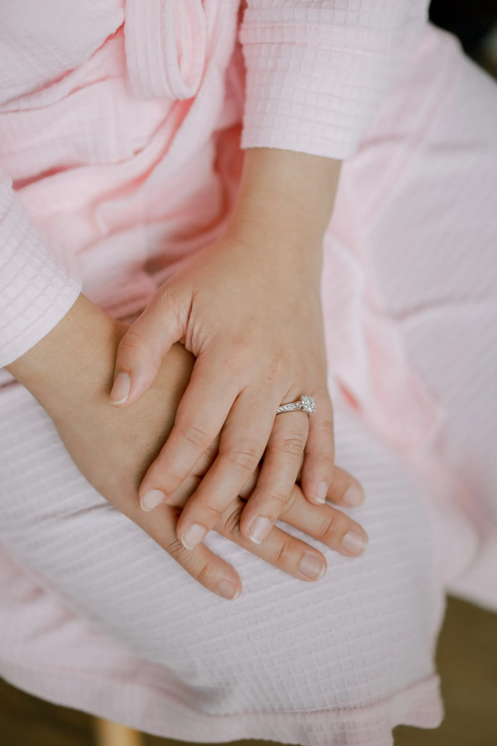 Queenstown New Zealand Elopement Wedding Photographer - A woman's hands holding a wedding ring at Lam and Wendy's Kamana Lakehouse Wedding.