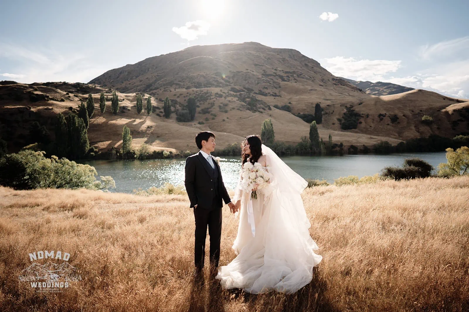Queenstown New Zealand Elopement Wedding Photographer - Keywords: FIELD, LAKE

Description: A bride and groom posing in a picturesque field by a serene lake.