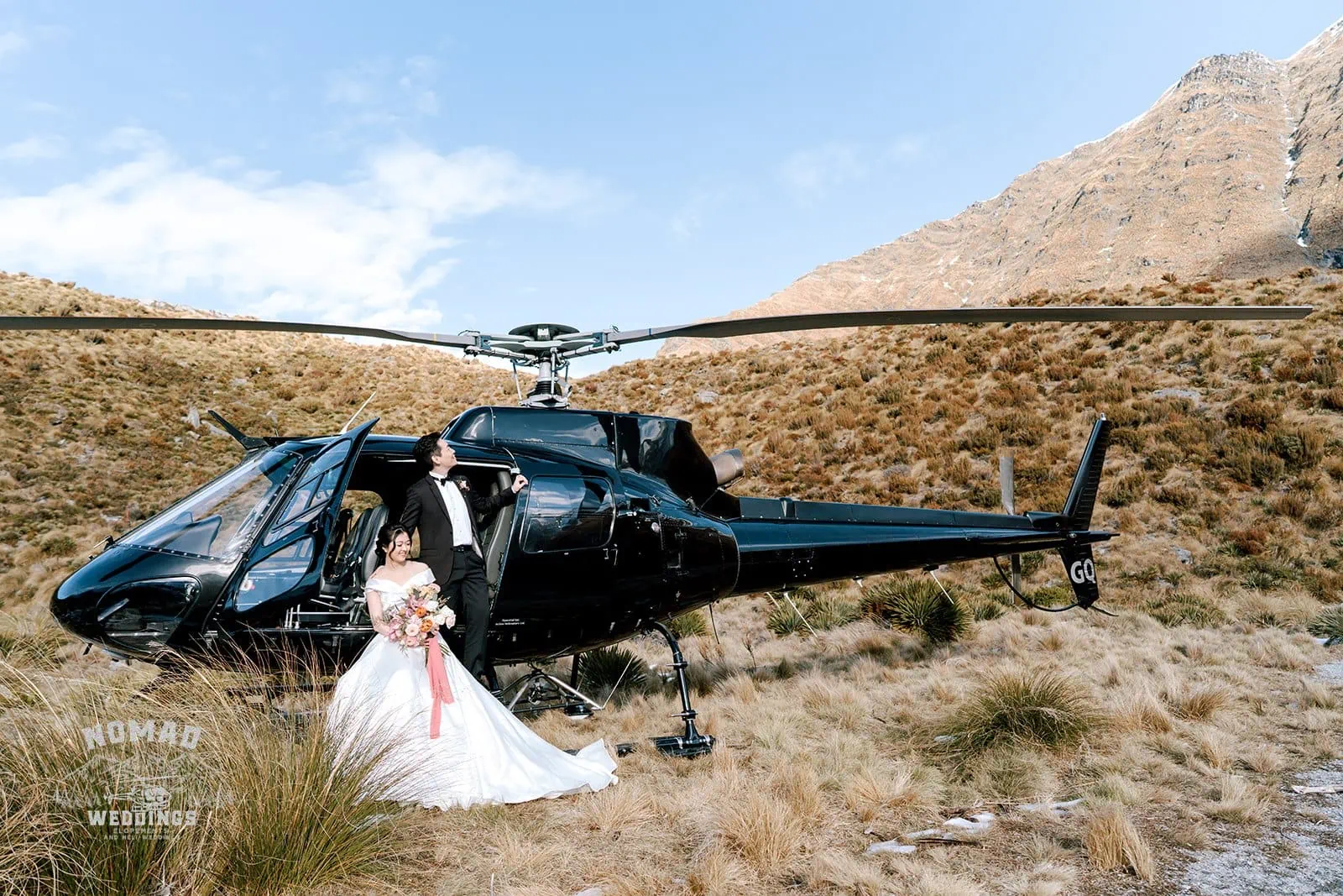 Queenstown New Zealand Elopement Wedding Photographer - Bo and Junyi's heli pre wedding shoot took place in the mountains, with 4 landings, and featured a bride and groom next to a helicopter.