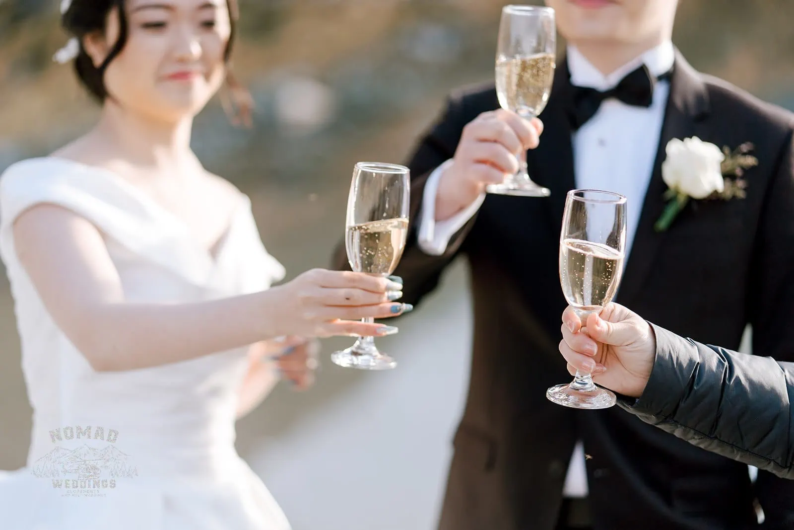 Queenstown New Zealand Elopement Wedding Photographer - A pre-wedding photoshoot featuring Bo and Junyi with champagne glasses.