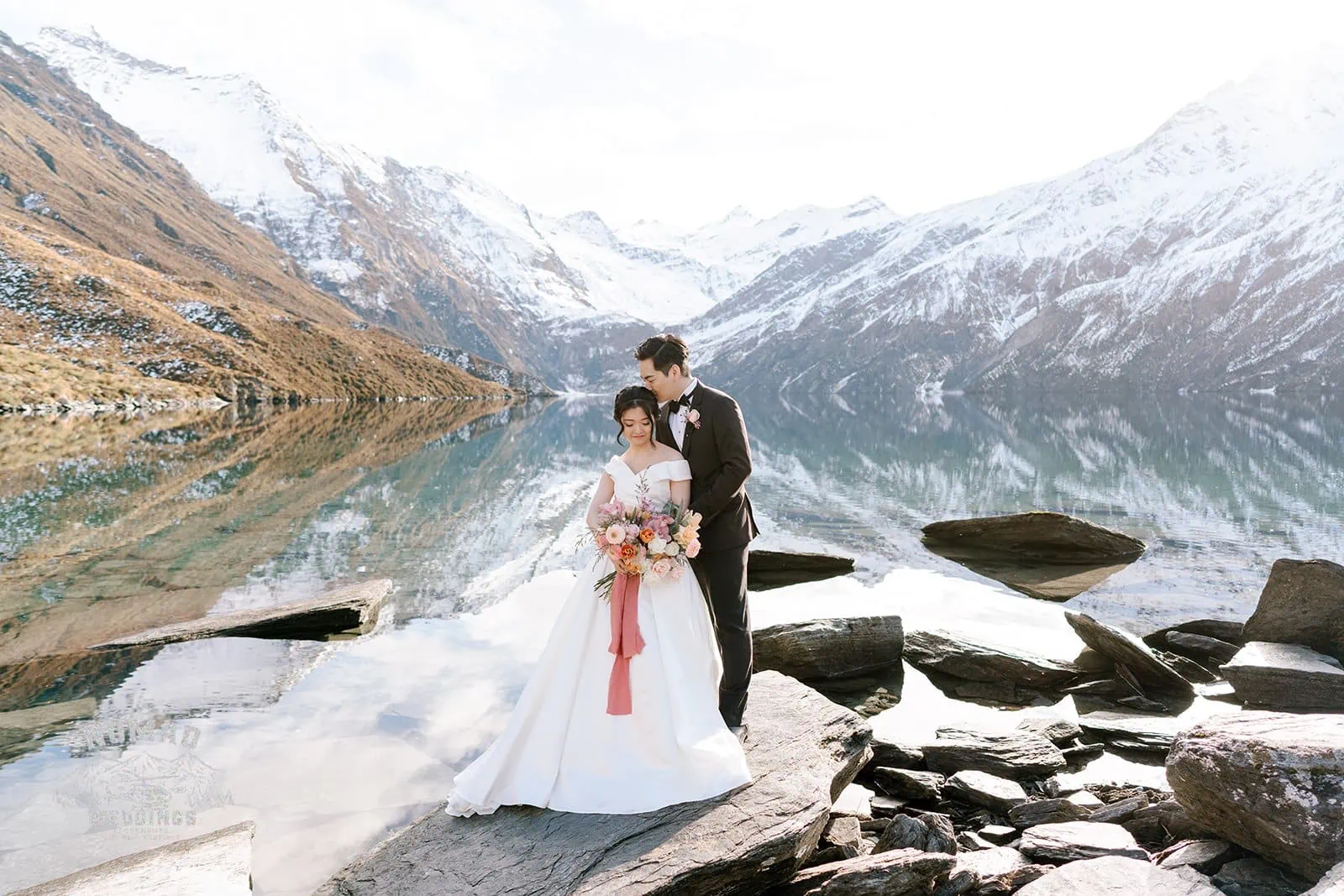 Queenstown New Zealand Elopement Wedding Photographer - Bo and Junyi's Heli Pre Wedding Shoot featuring a lake and mountains in the background.