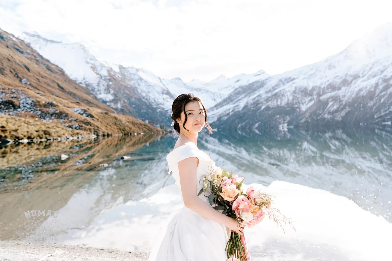 Queenstown New Zealand Elopement Wedding Photographer - A couple named Bo and Junyi posing in front of a lake during their Heli Pre Wedding Shoot with 4 Landings.