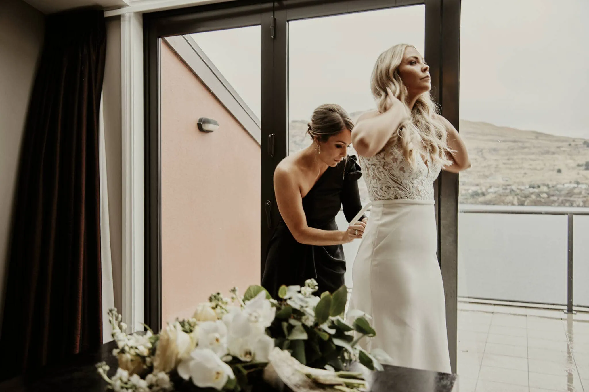 Queenstown New Zealand Elopement Wedding Photographer - Rebecca and Dylan's enchanting wedding dress moment on a balcony overlooking Moke Lake.