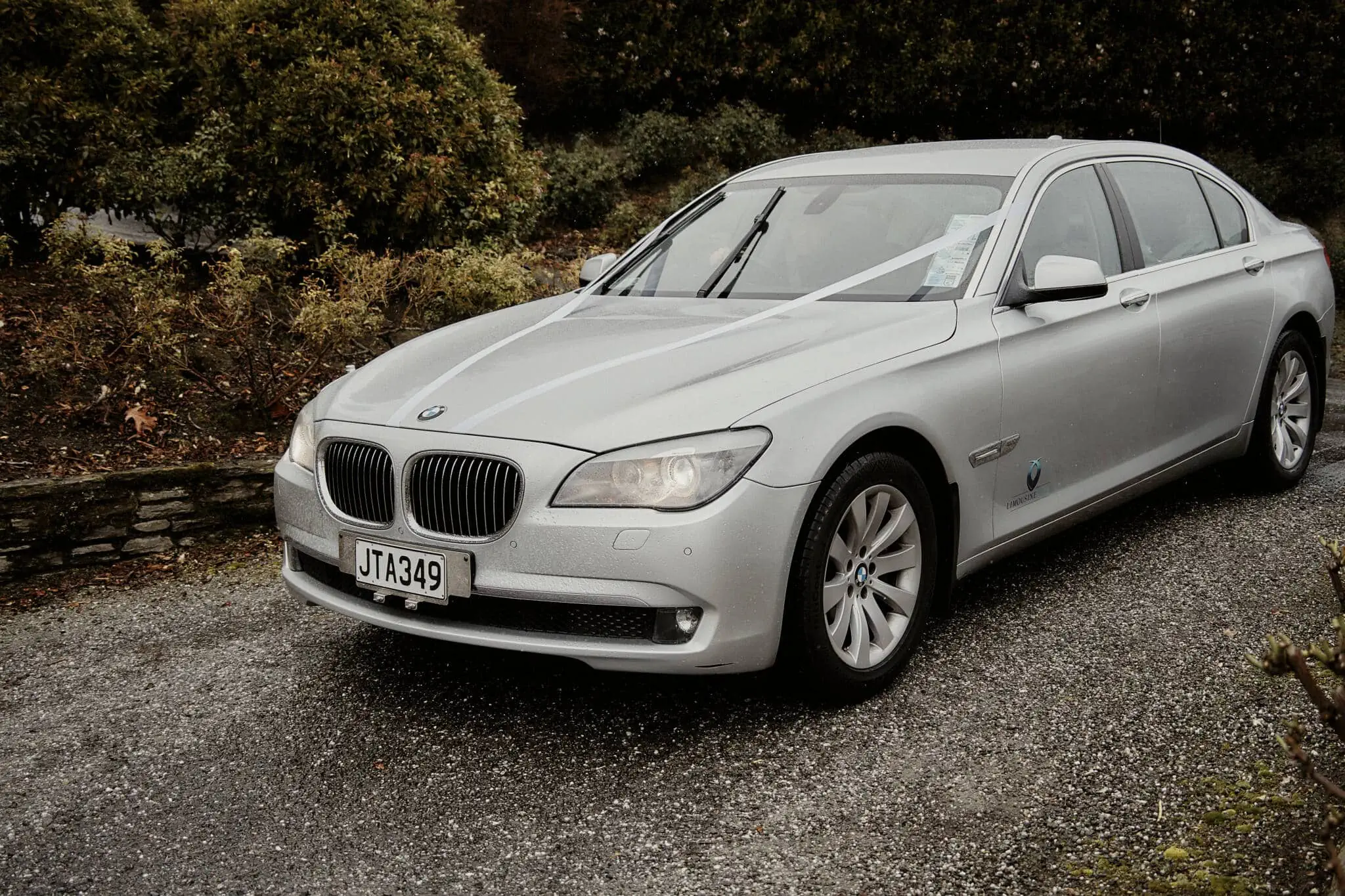 Queenstown New Zealand Elopement Wedding Photographer - A silver BMW 7 Series parked on a gravel road at Wasim and Yumn's Queenstown Islamic Wedding.