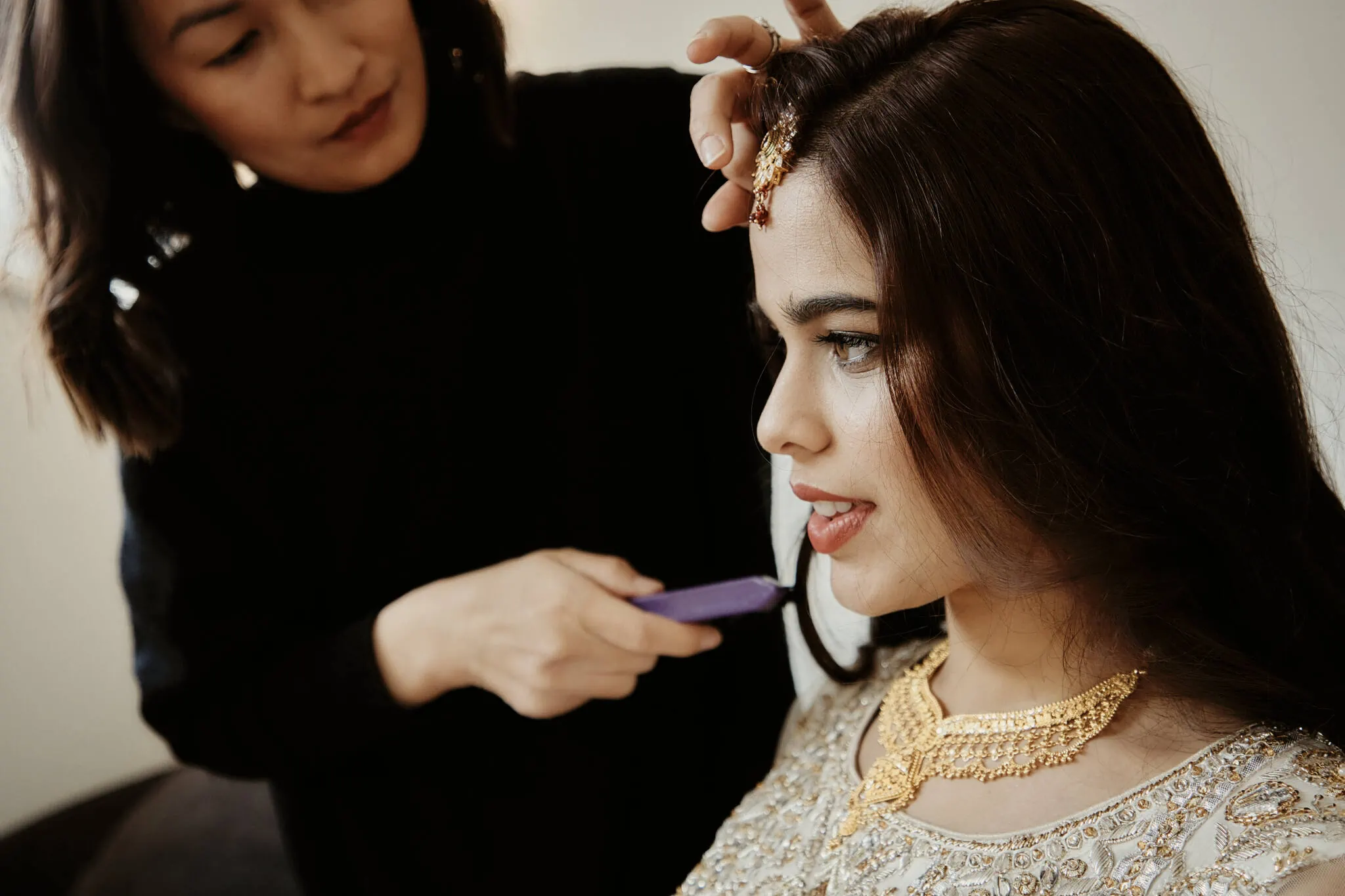 Queenstown New Zealand Elopement Wedding Photographer - Queenstown Islamic Wedding: A woman is getting her hair done by a hairdresser named Yumn.