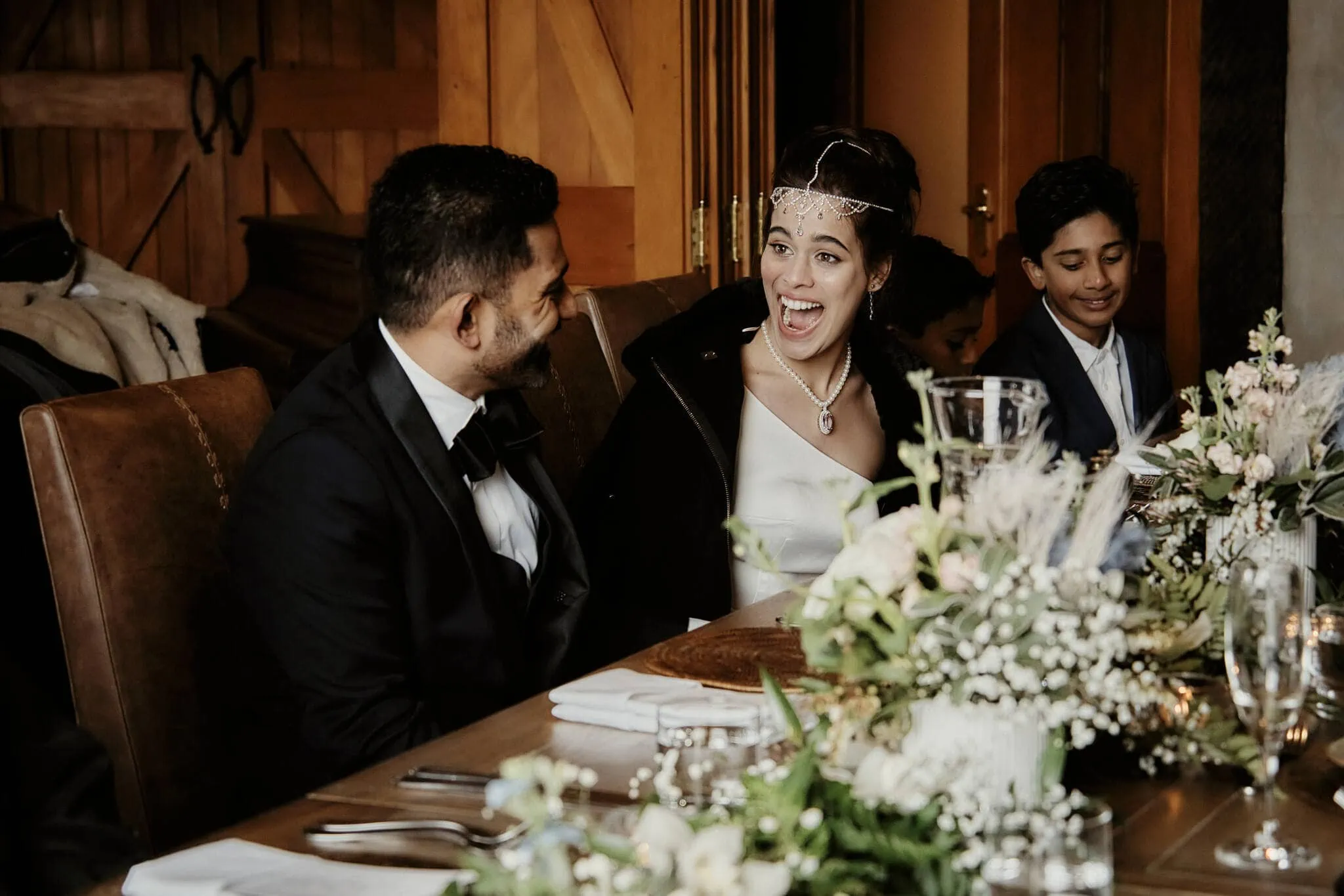 Queenstown New Zealand Elopement Wedding Photographer - Keywords: bride, groom, dinner table

Description: Wasim and Yumn laughing at their dinner table during their Queenstown Islamic wedding.