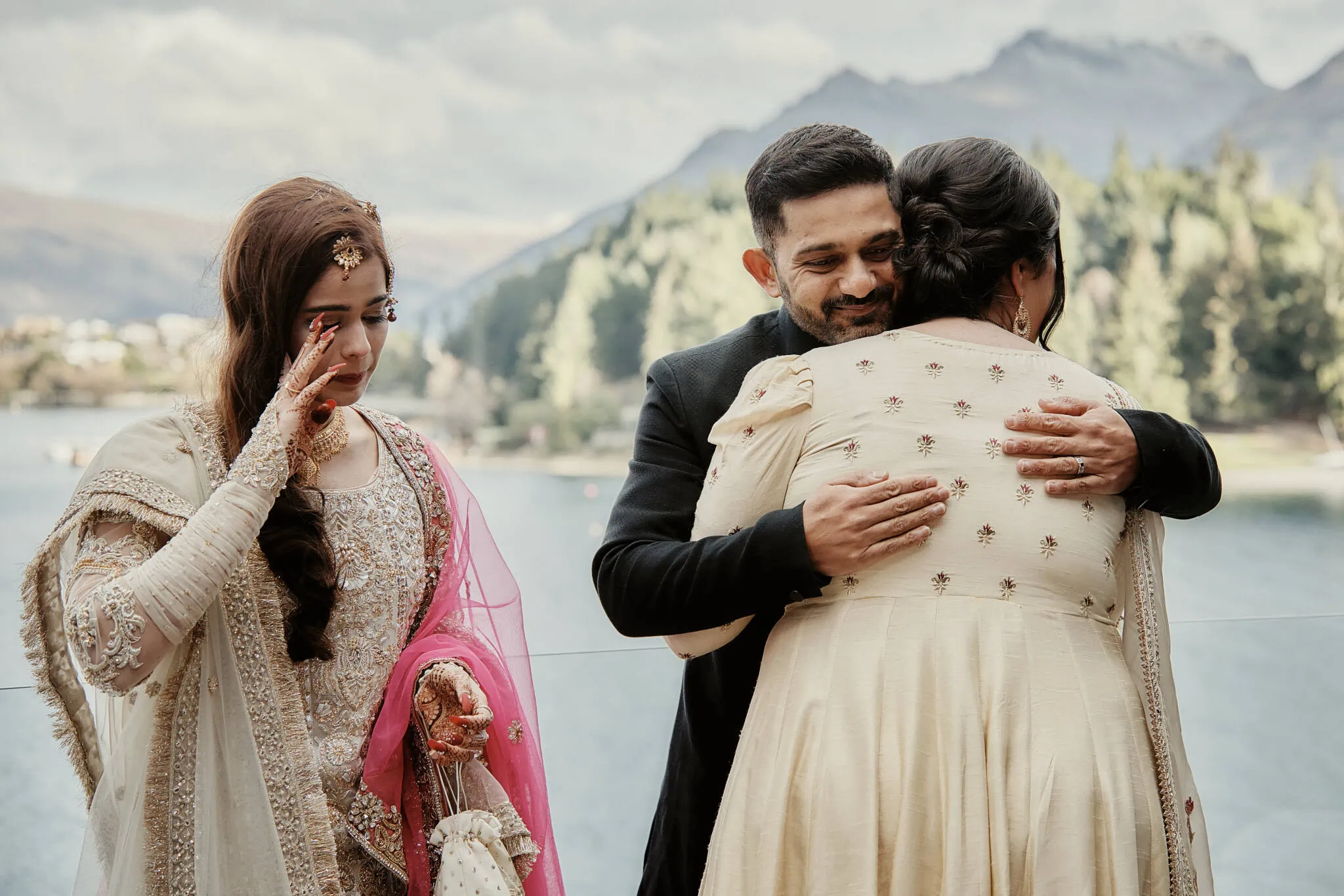Queenstown New Zealand Elopement Wedding Photographer - Wasim and Yumn's beautiful Islamic wedding - a bride and groom hugging beside a lake in Queenstown.